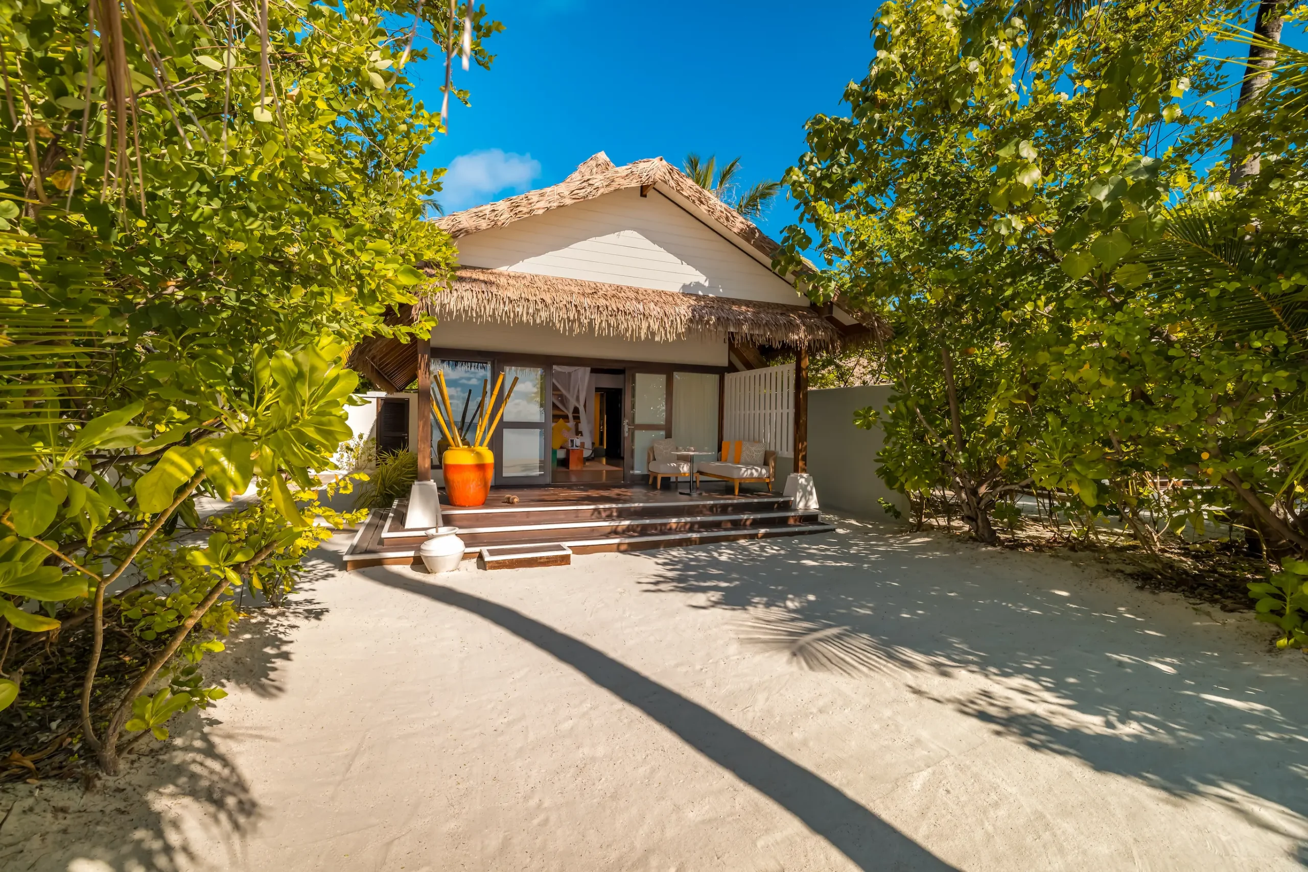 Exterior view of an Earth Villa at OZEN LIFE MAADHOO, showcasing the beachfront setting, contemporary architecture and private outdoor living space