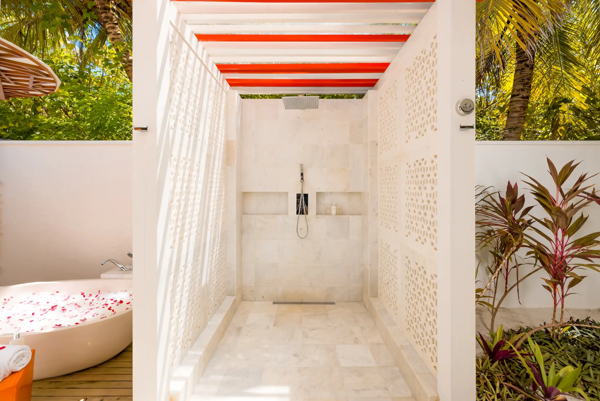 Outdoor shower at an Earth Villa at OZEN LIFE MAADHOO, set within a private open-air bathroom surrounded by tropical garden landscaping