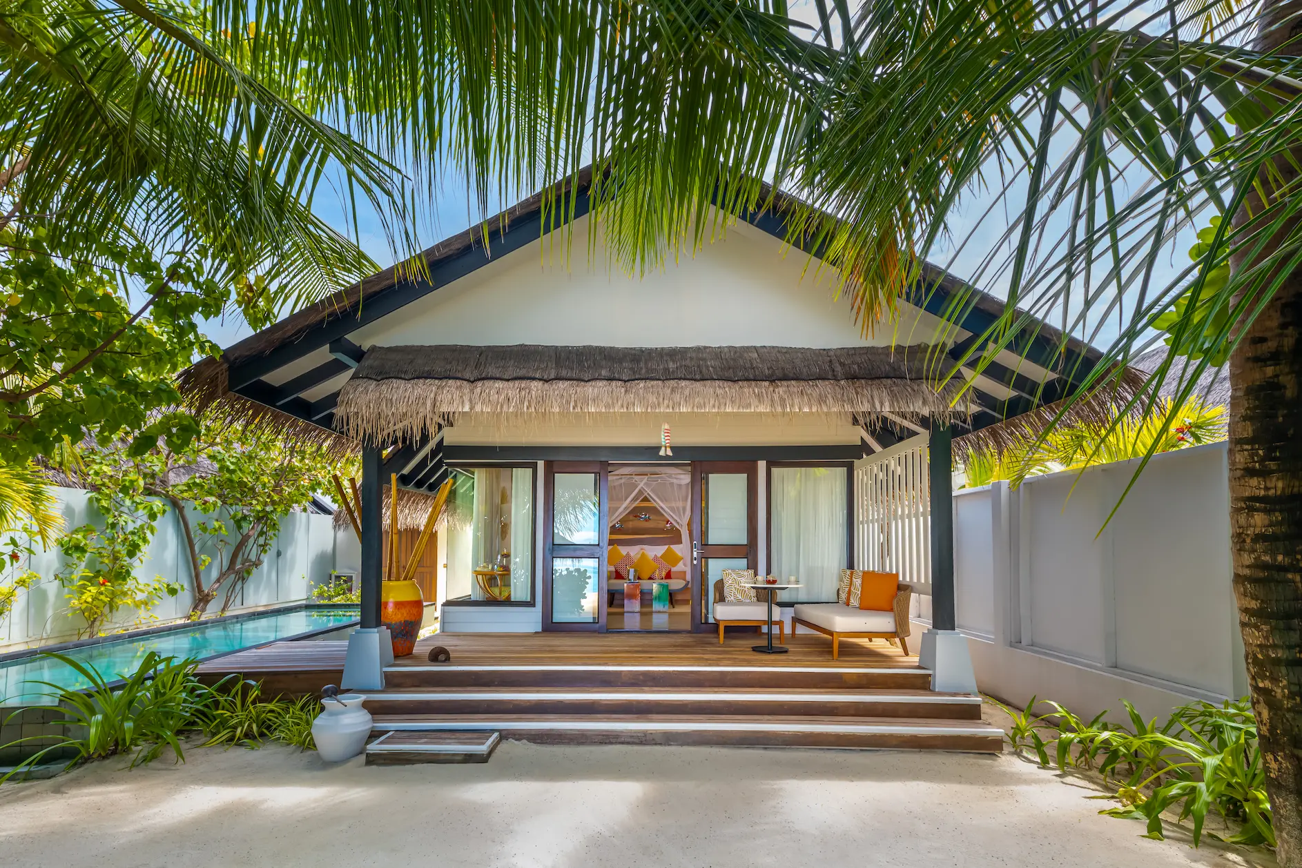 Exterior view of an Earth Villa with Pool at OZEN LIFE MAADHOO, showcasing the beachfront location, contemporary architecture, private infinity pool and outdoor living spaces