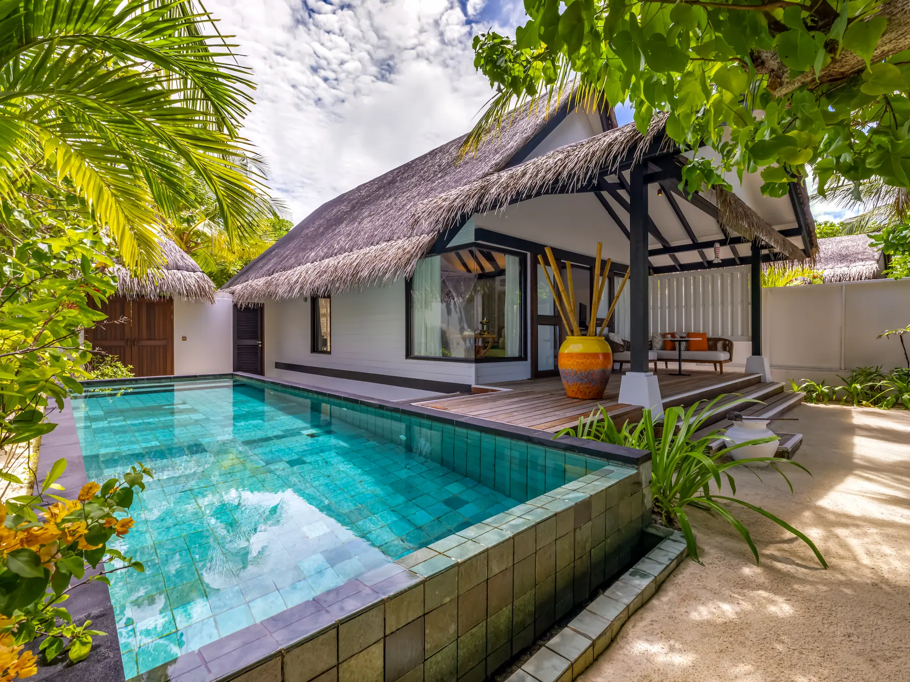 Private infinity pool at an Earth Villa with Pool at OZEN LIFE MAADHOO, overlooking the beachfront setting and surrounding island landscape