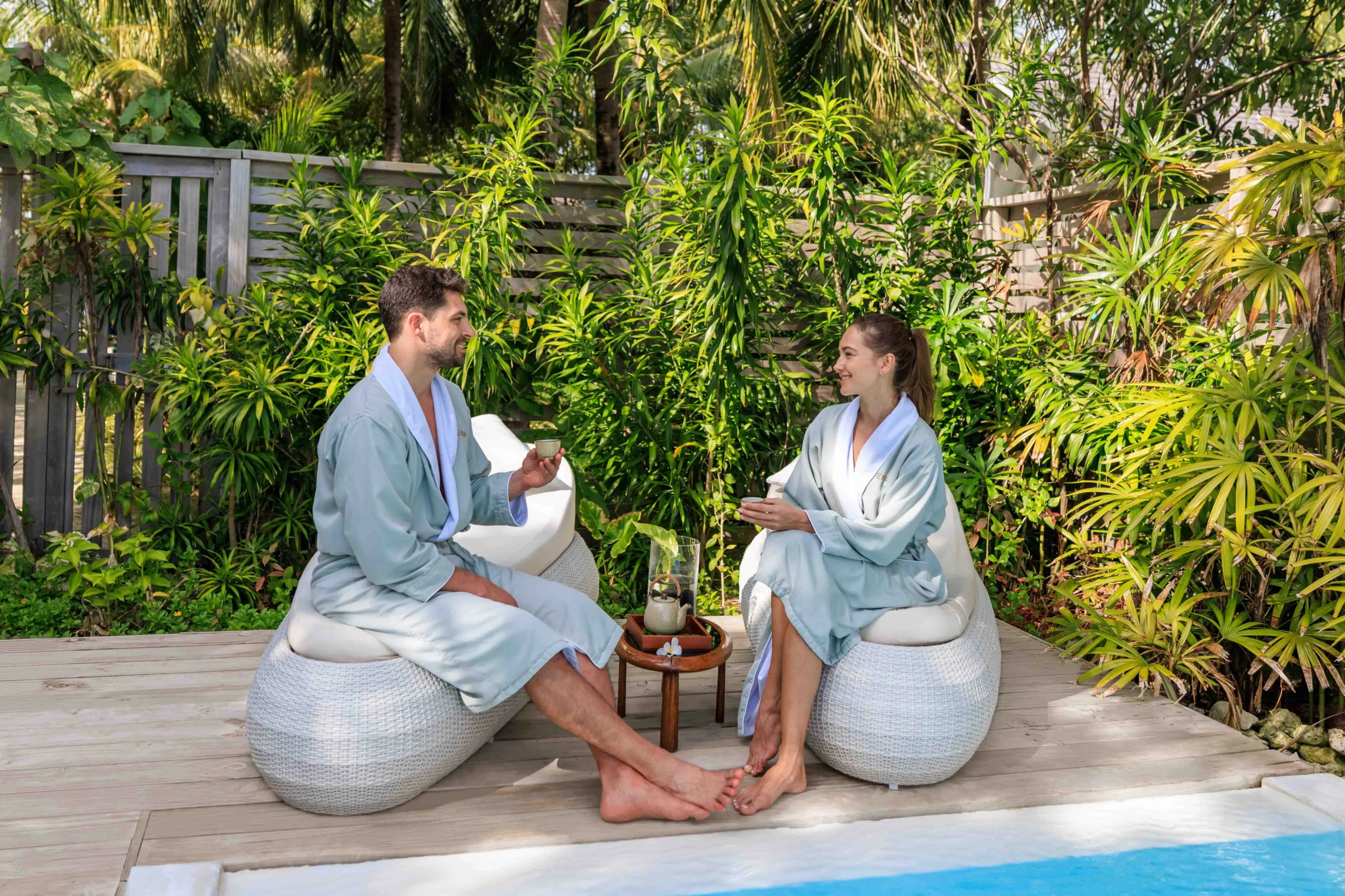 Guests enjoying the salt pool at ELE | NA Spa at OZEN LIFE MAADHOO, surrounded by wellness facilities and views across the lagoon.