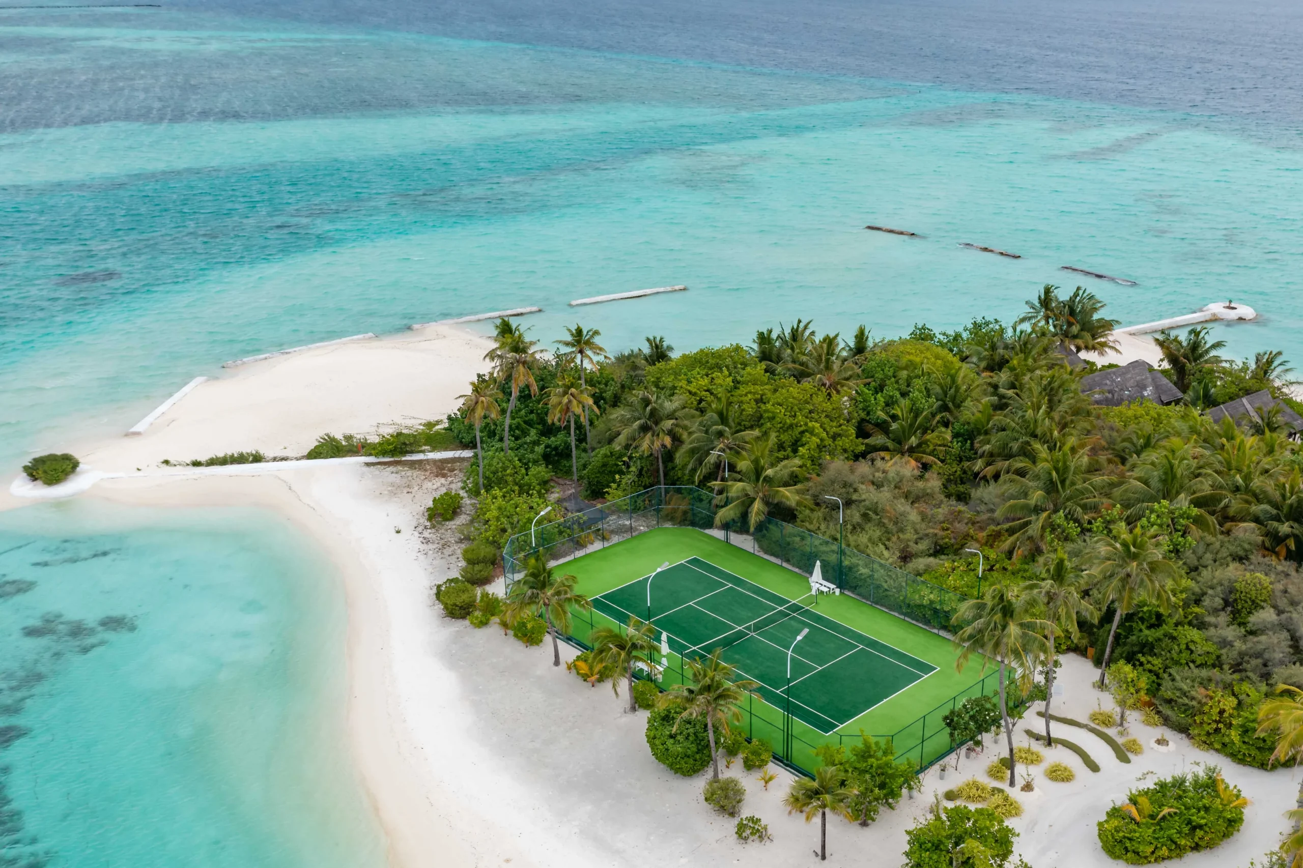 Tennis court at OZEN LIFE MAADHOO, providing guests with an outdoor sports facility surrounded by the island setting of South Malé Atoll.