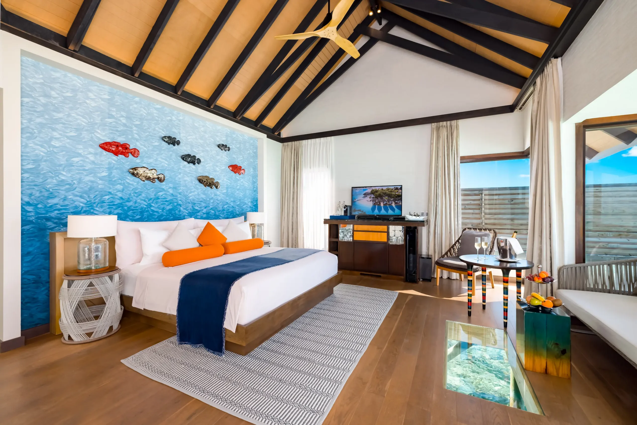 Bedroom in a Wind Villa at OZEN LIFE MAADHOO featuring contemporary interiors, overwater positioning and views across the lagoon.