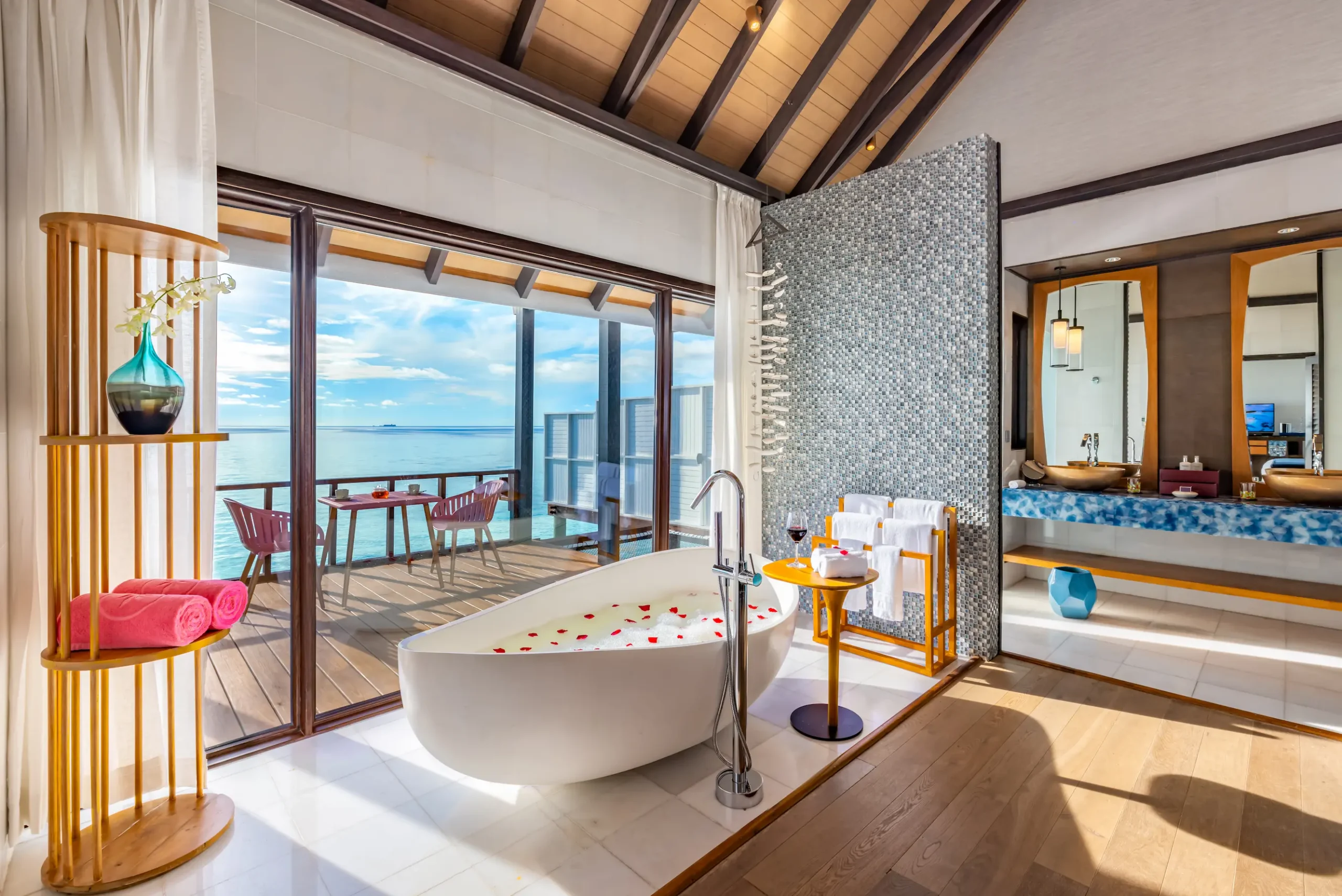 Freestanding bathtub in a Wind Villa with Pool at OZEN LIFE MAADHOO, positioned to enjoy views across the lagoon from the resort's overwater accommodation