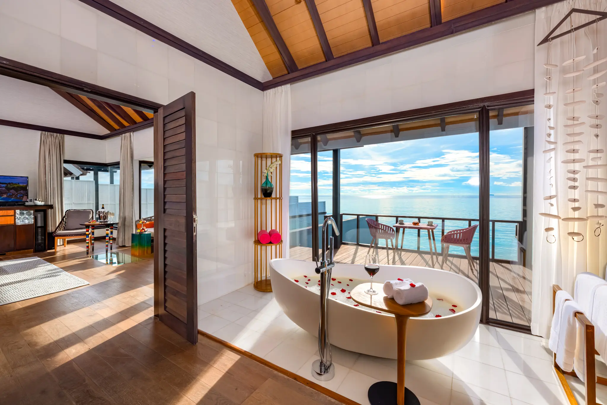Bathroom in a Wind Villa with Pool at OZEN LIFE MAADHOO featuring a freestanding bathtub, WC area and contemporary overwater villa design overlooking the lagoon