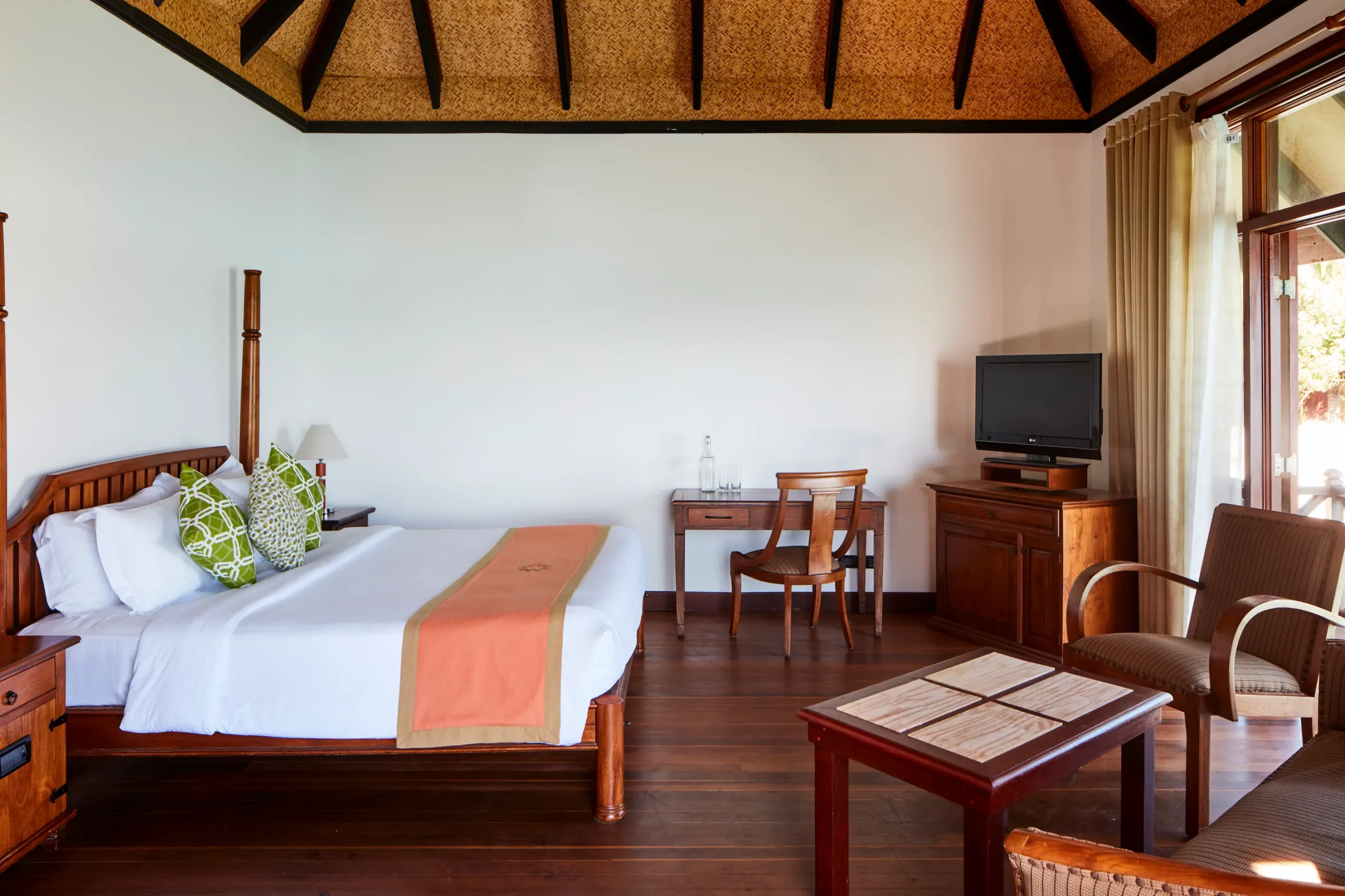 bedroom in a water villa at sun siyam olhuveli maldives featuring overwater accommodation and lagoon views