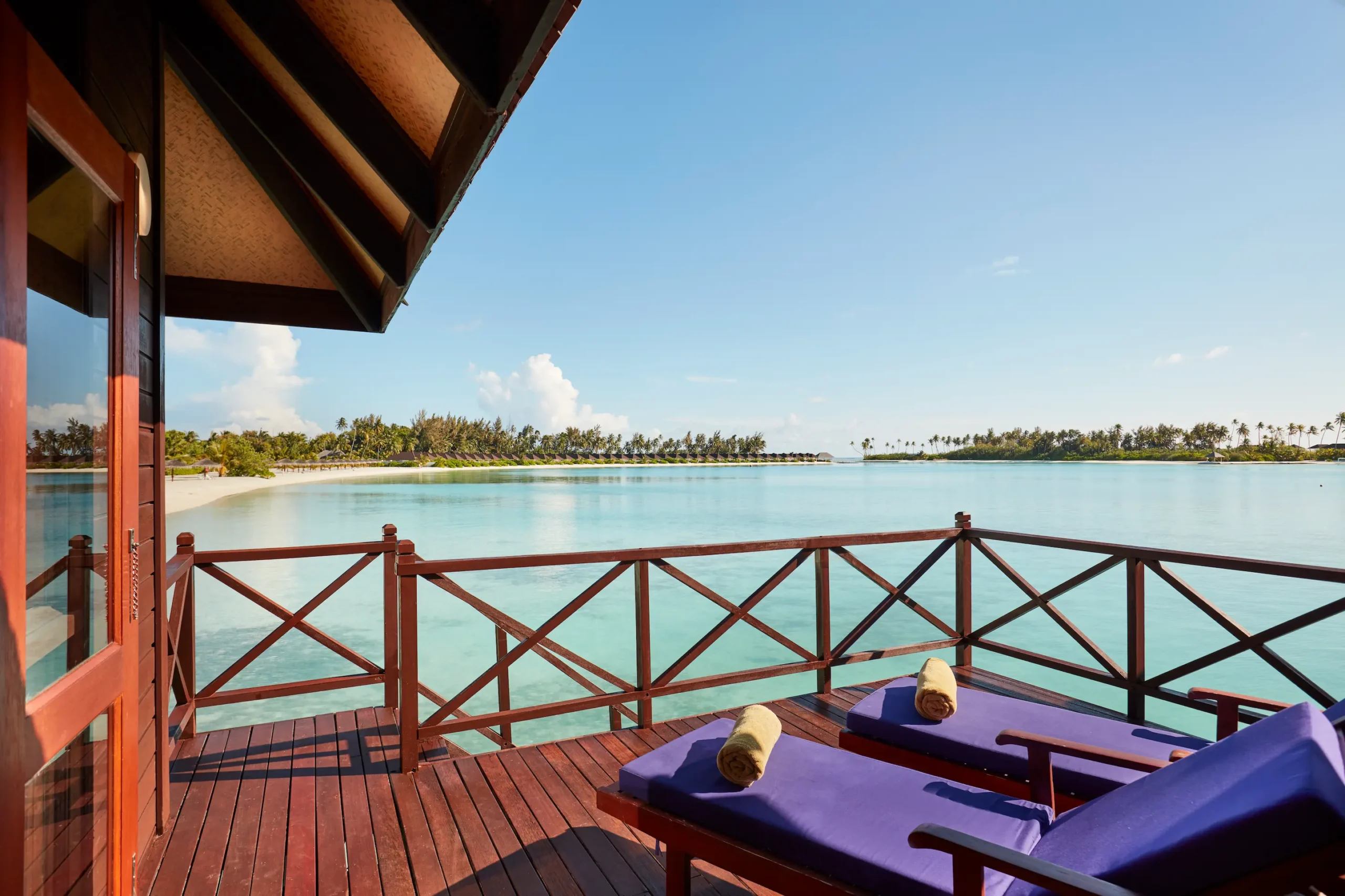 private deck of a water villa at sun siyam olhuveli maldives with direct access to the lagoon