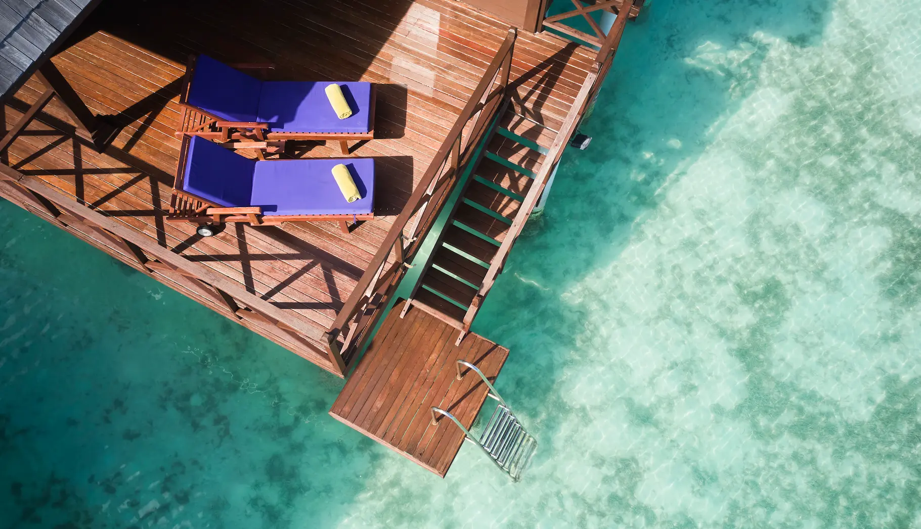 aerial view of water villas at sun siyam olhuveli maldives extending over the lagoon