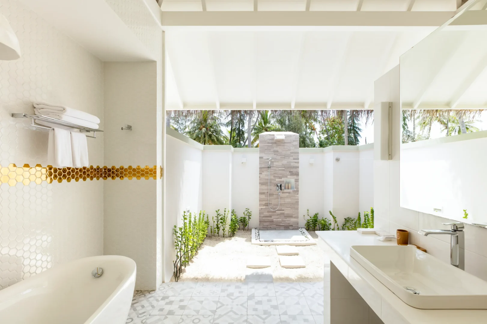 bathroom in a grand beach villa at sun siyam olhuveli maldives featuring modern amenities and a spacious indoor outdoor design