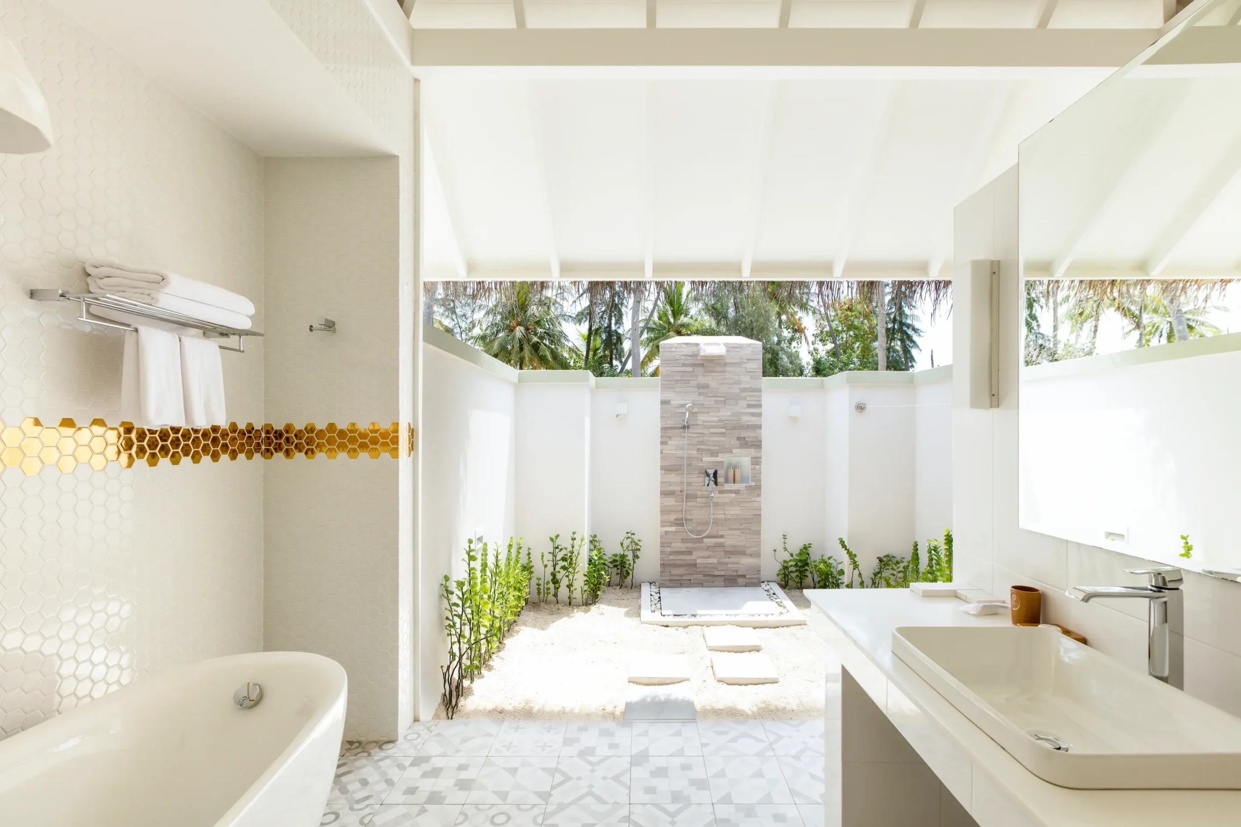 bathroom in a grand beach villa at sun siyam olhuveli maldives featuring modern amenities and a spacious indoor outdoor design
