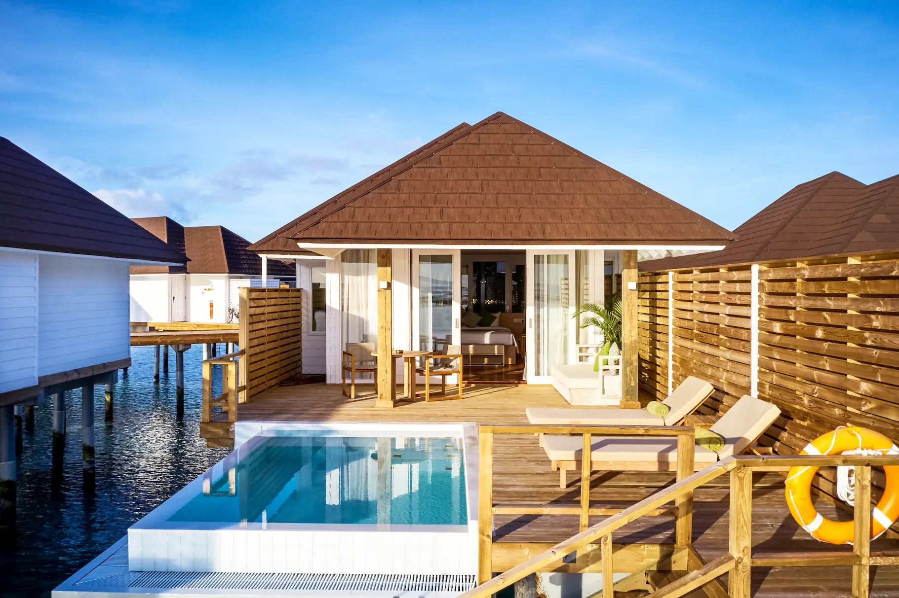 exterior view of a grand water villa with pool at sun siyam olhuveli maldives positioned above the lagoon with a private pool and direct water access