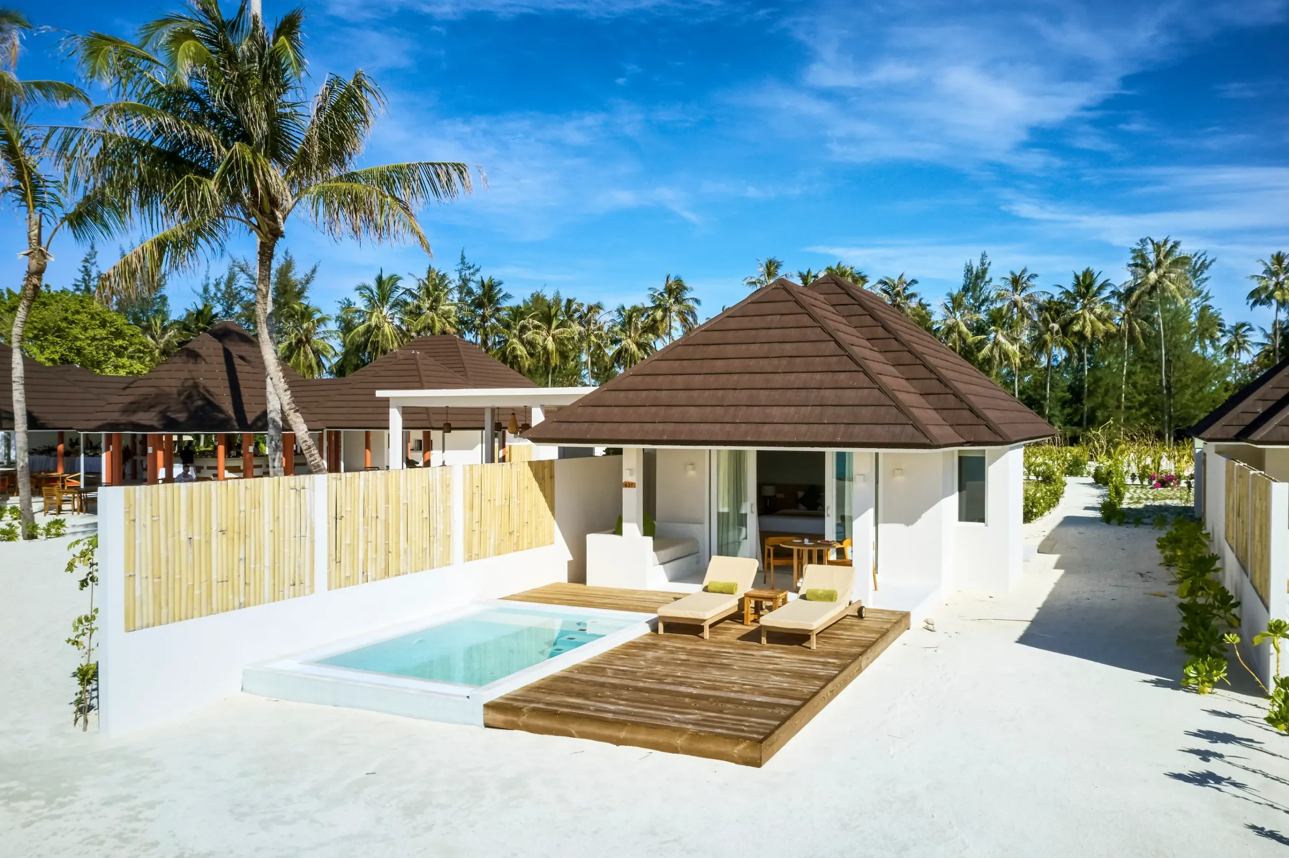 drone view of a grand beach villa with pool at sun siyam olhuveli maldives located along the beachfront