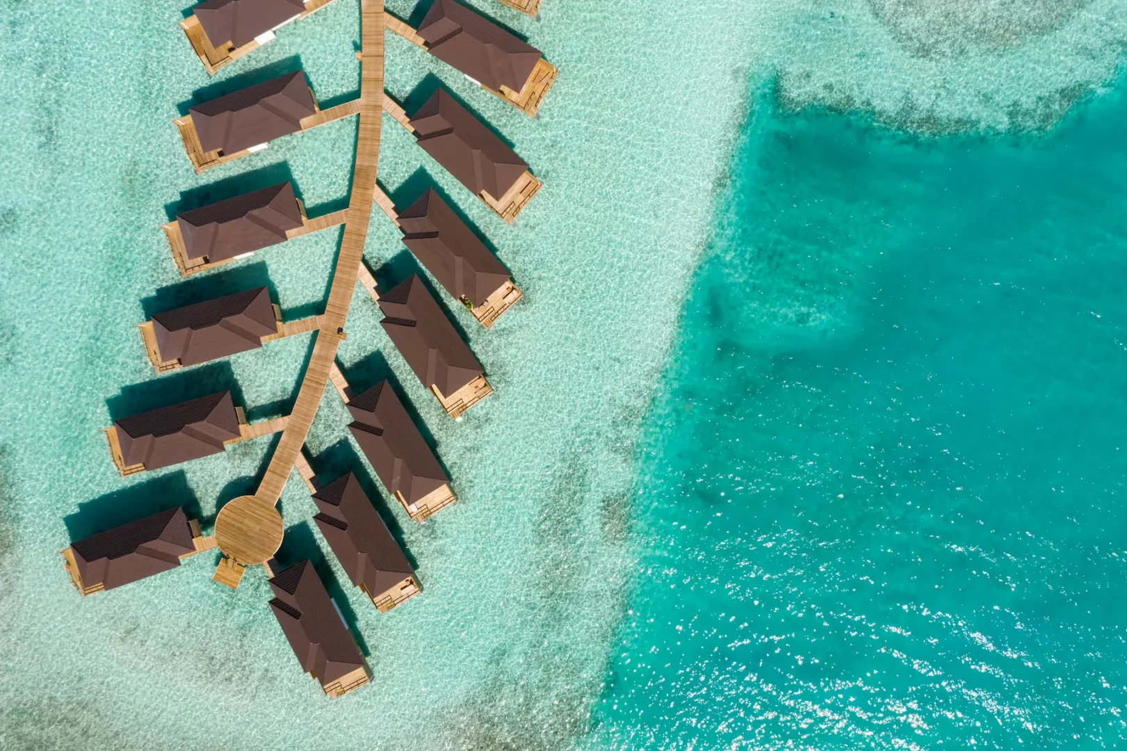 aerial view of grand water villas at sun siyam olhuveli maldives extending across the lagoon