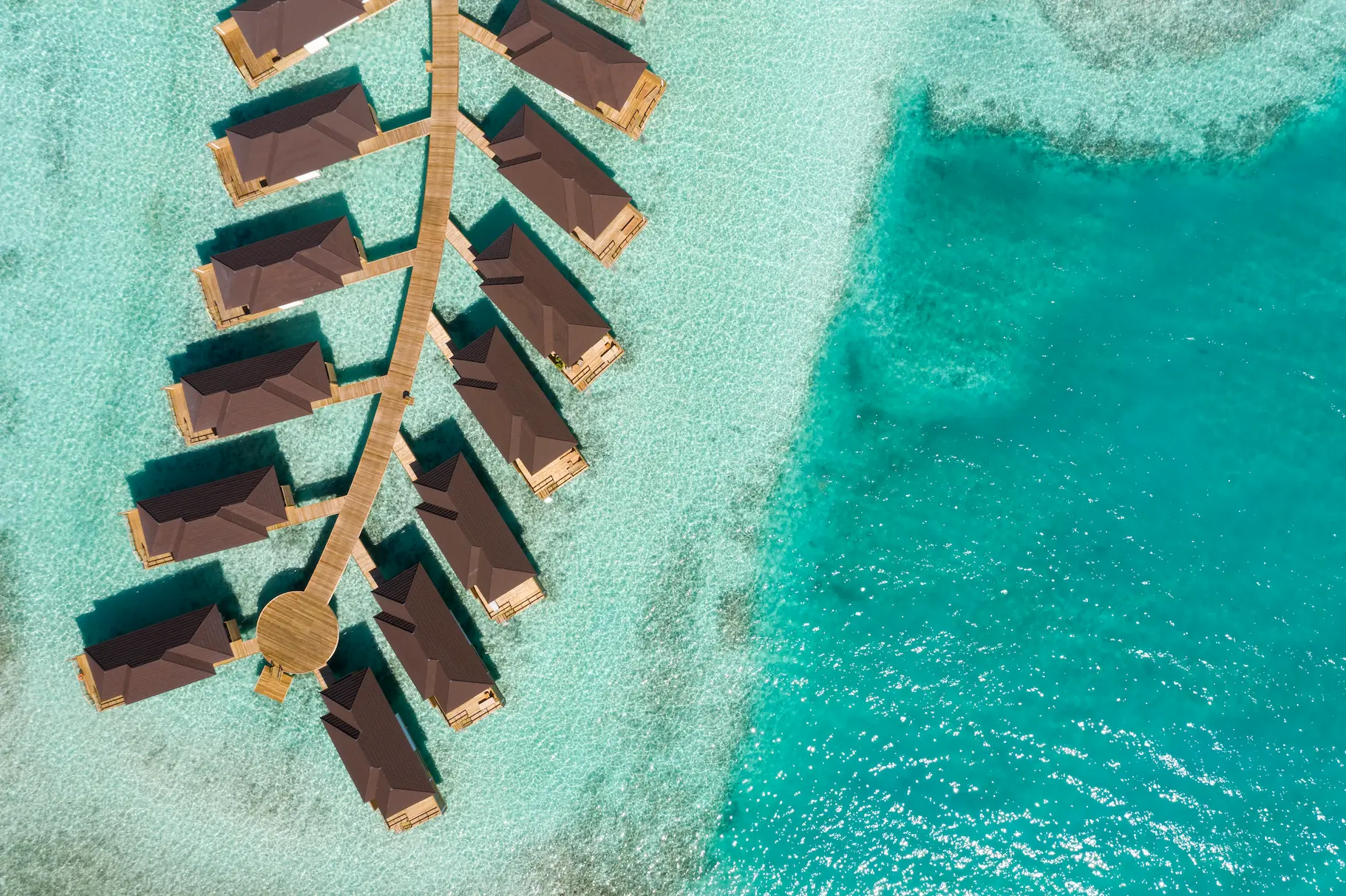 aerial view of grand water villas at sun siyam olhuveli maldives extending across the lagoon
