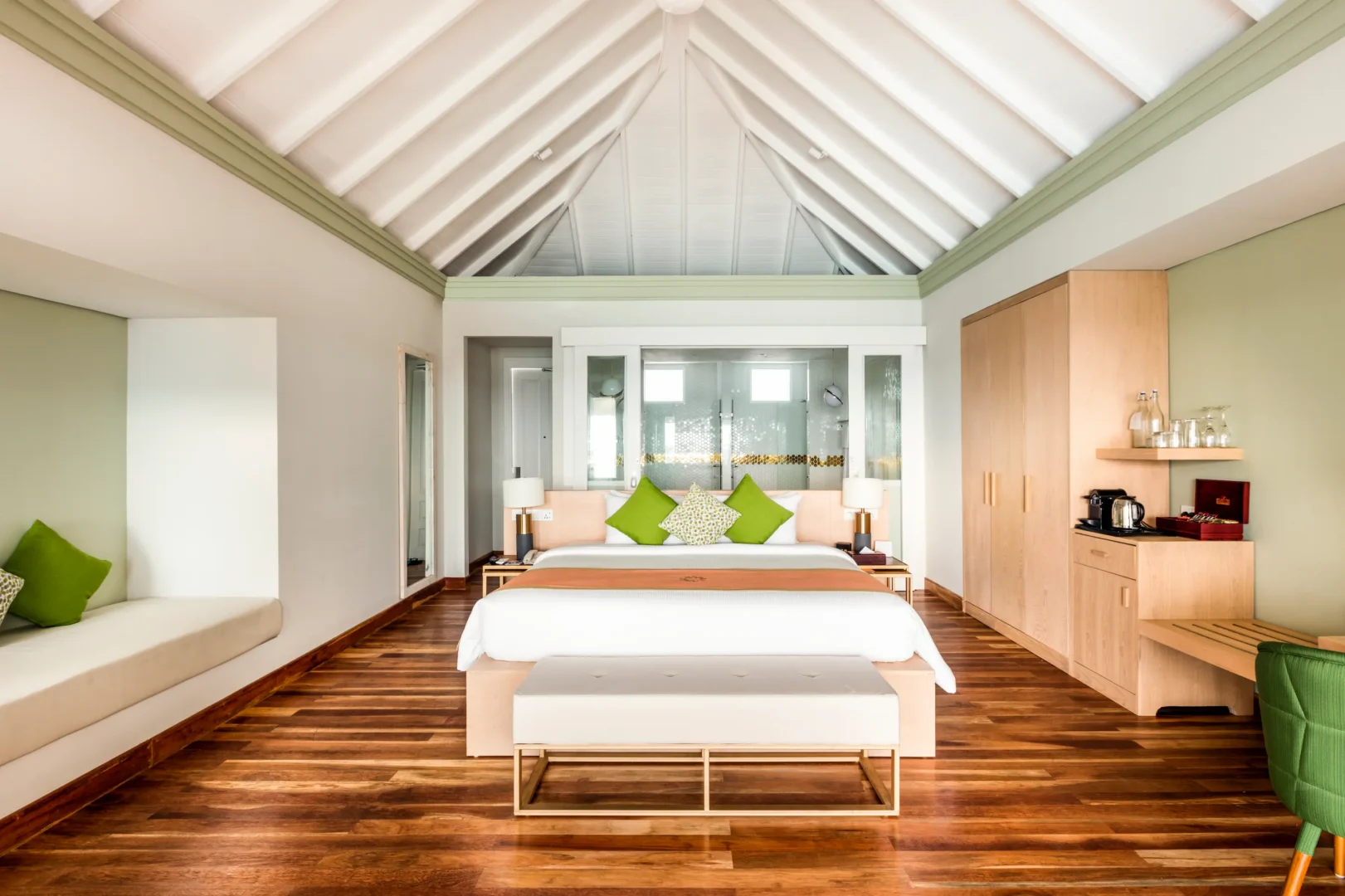 bedroom interior of a grand water villa with pool at sun siyam olhuveli maldives featuring contemporary furnishings and an overwater setting