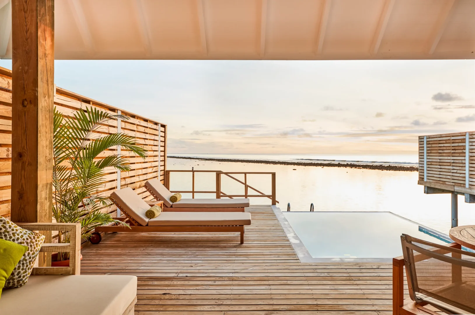 private terrace of a grand water villa with pool at sun siyam olhuveli maldives featuring outdoor relaxation space above the lagoon