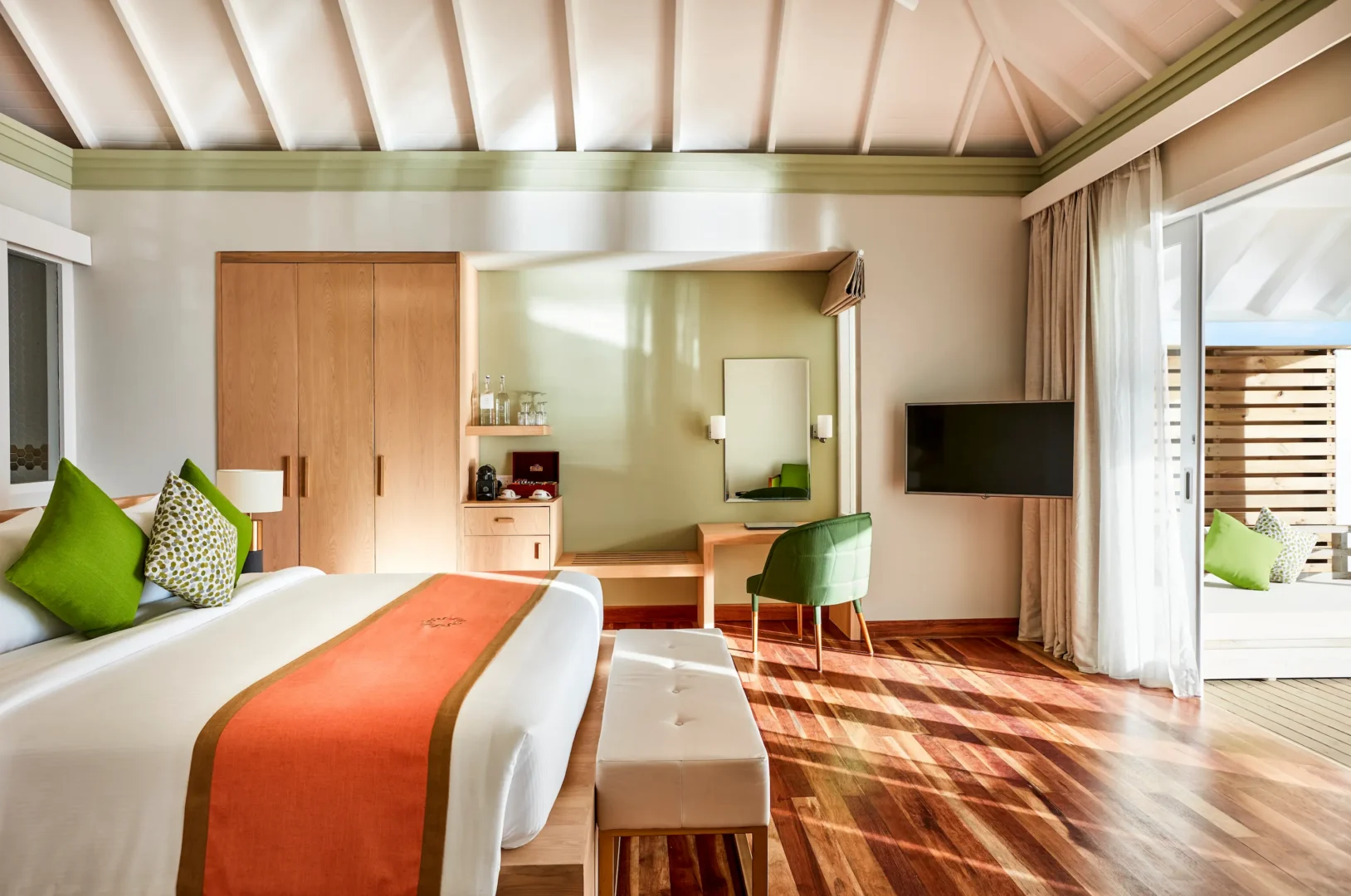bedroom in a grand water villa with pool at sun siyam olhuveli maldives featuring contemporary furnishings and an overwater setting