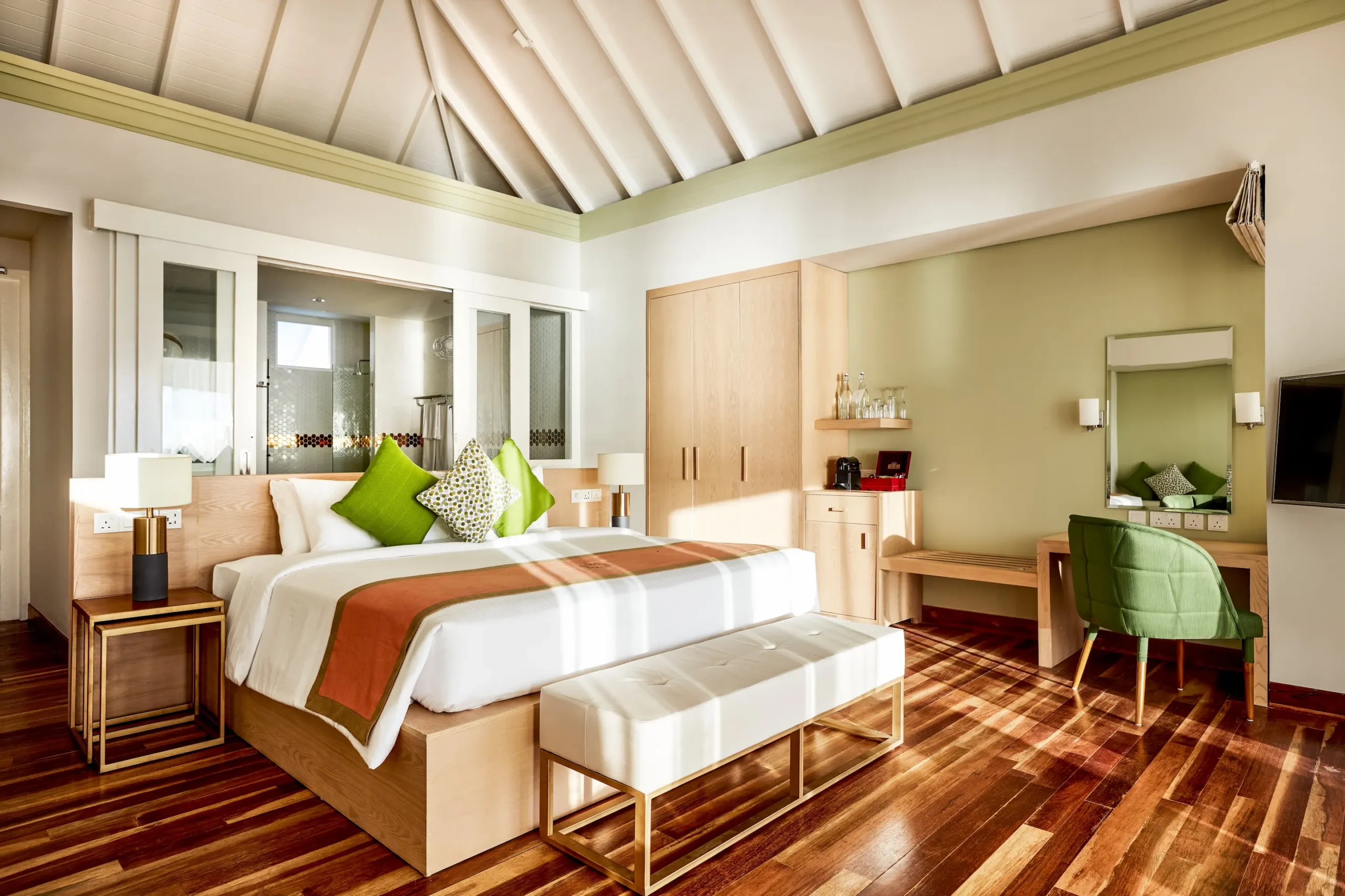 bedroom in a grand water villa at sun siyam olhuveli maldives featuring contemporary furnishings and an overwater setting