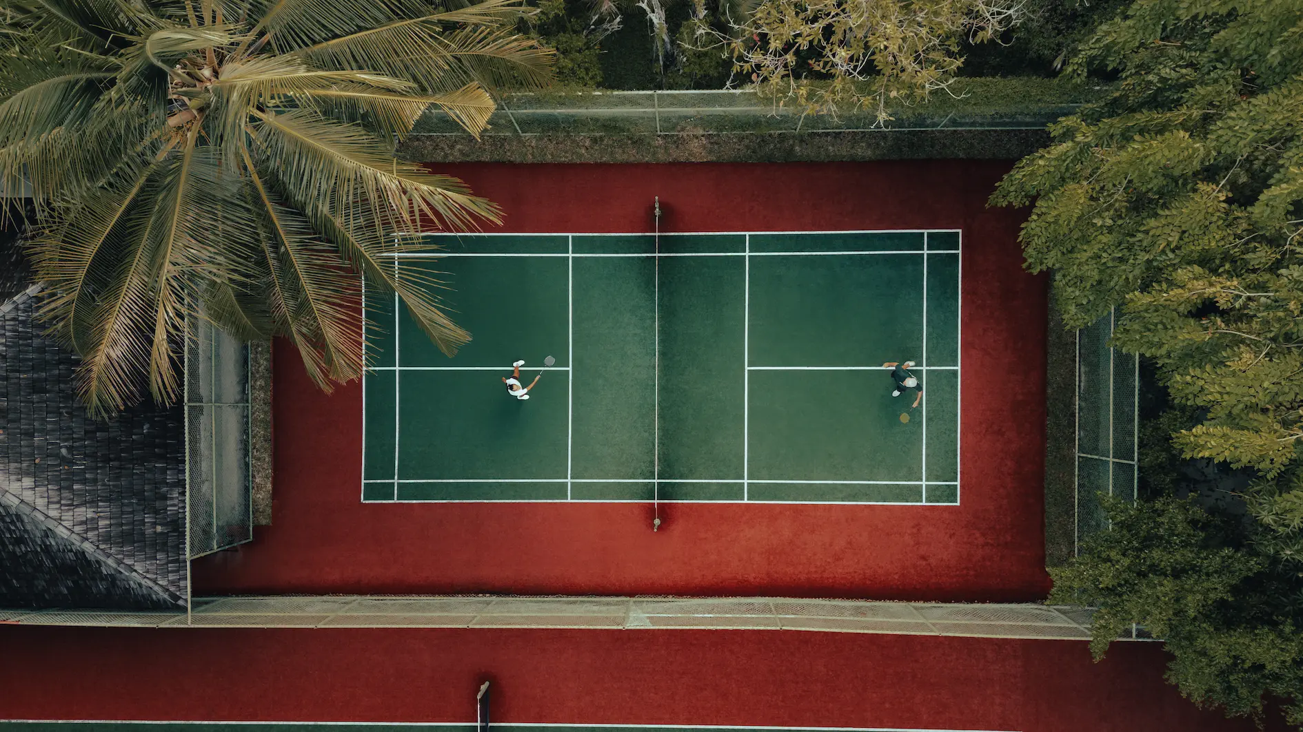 outdoor badminton and tennis court at sun siyam olhuveli maldives available for recreational sports and fitness activities