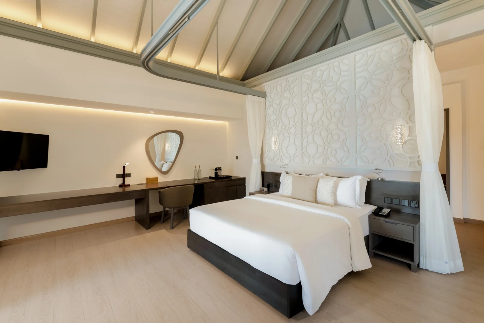 bedroom in a grand beach suite with pool at sun siyam olhuveli maldives featuring contemporary furnishings and spacious beachfront accommodation