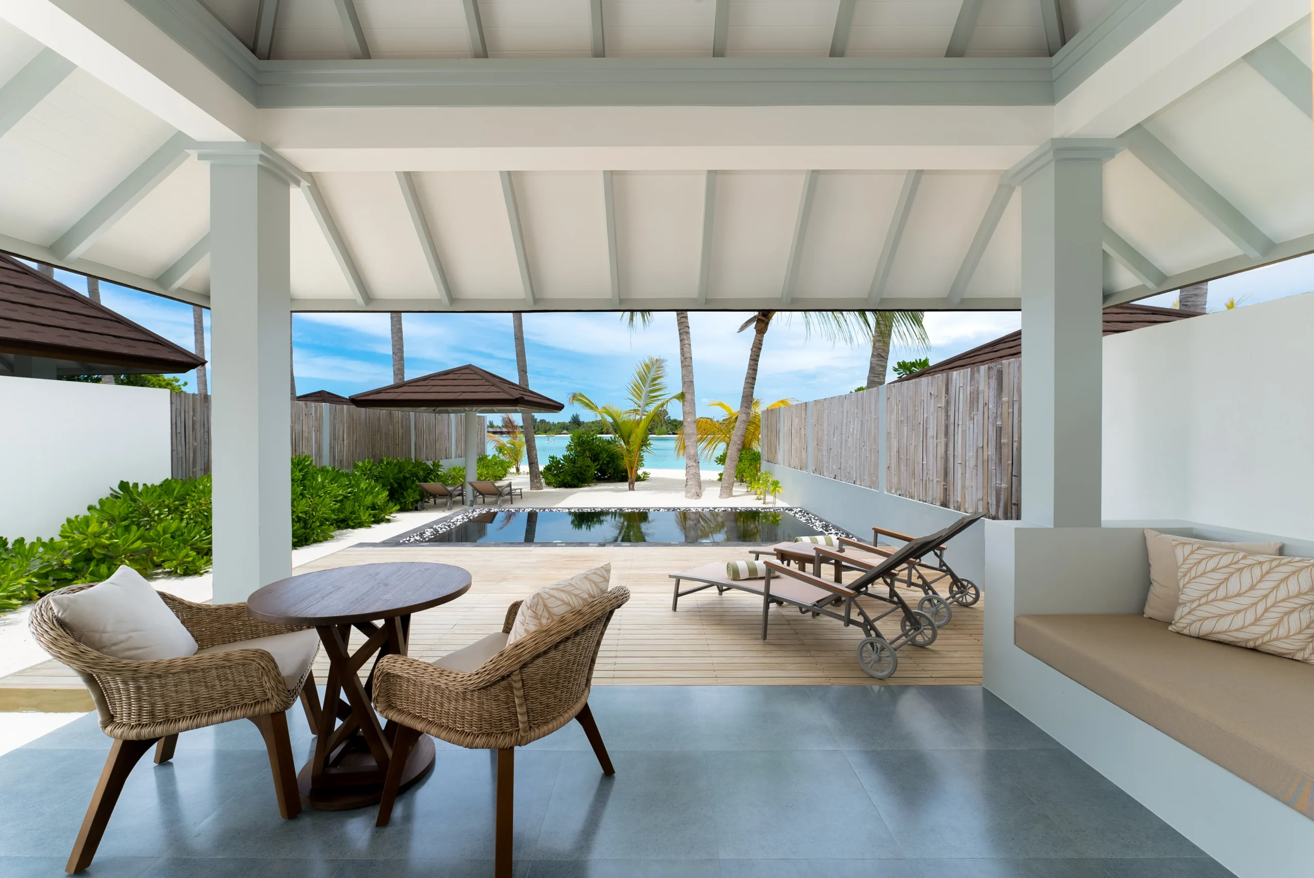 private terrace of a grand beach suite with pool at sun siyam olhuveli maldives featuring outdoor relaxation space and beachfront accommodation