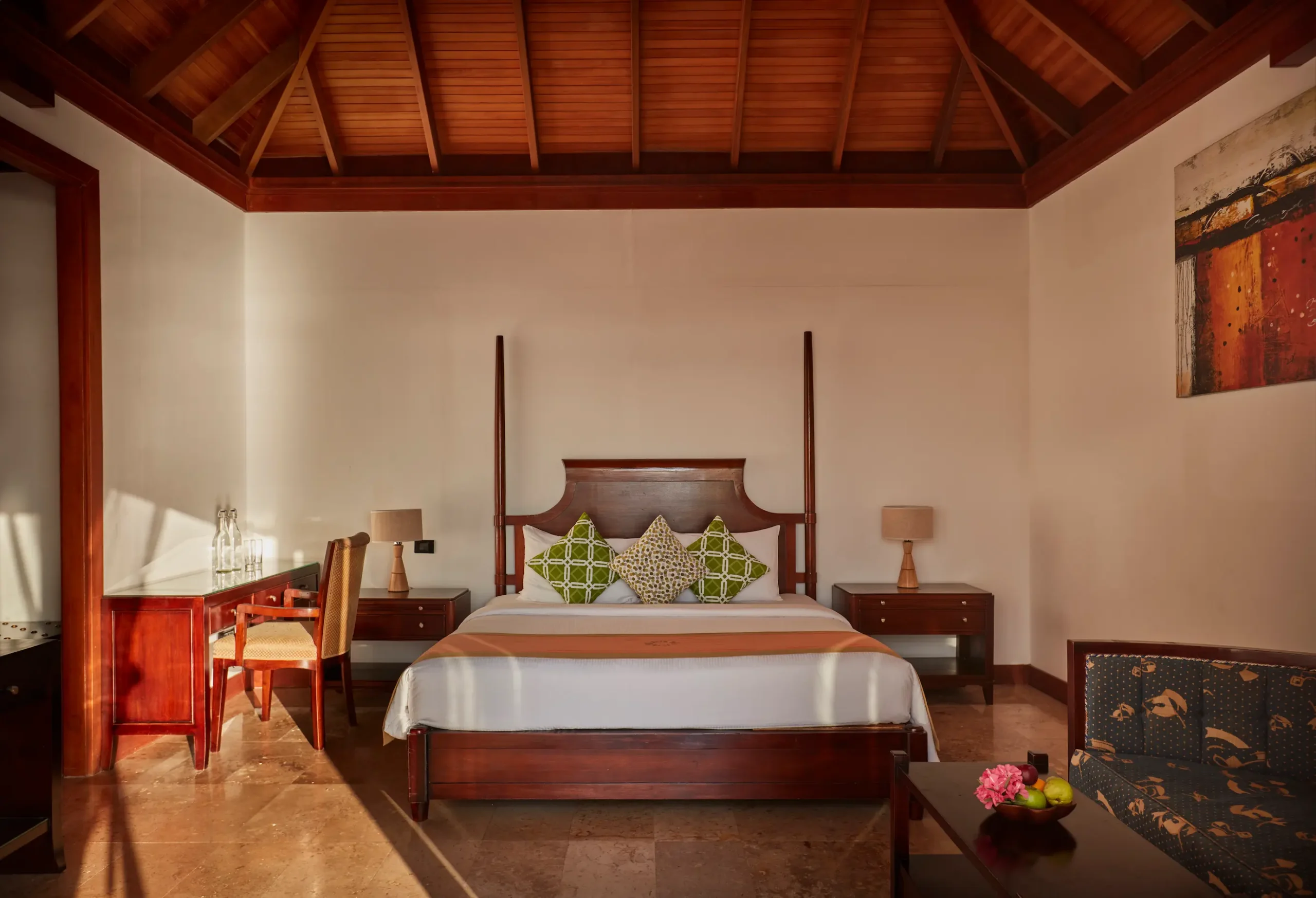 bedroom in a deluxe water villa at sun siyam olhuveli maldives featuring contemporary furnishings and views across the lagoon