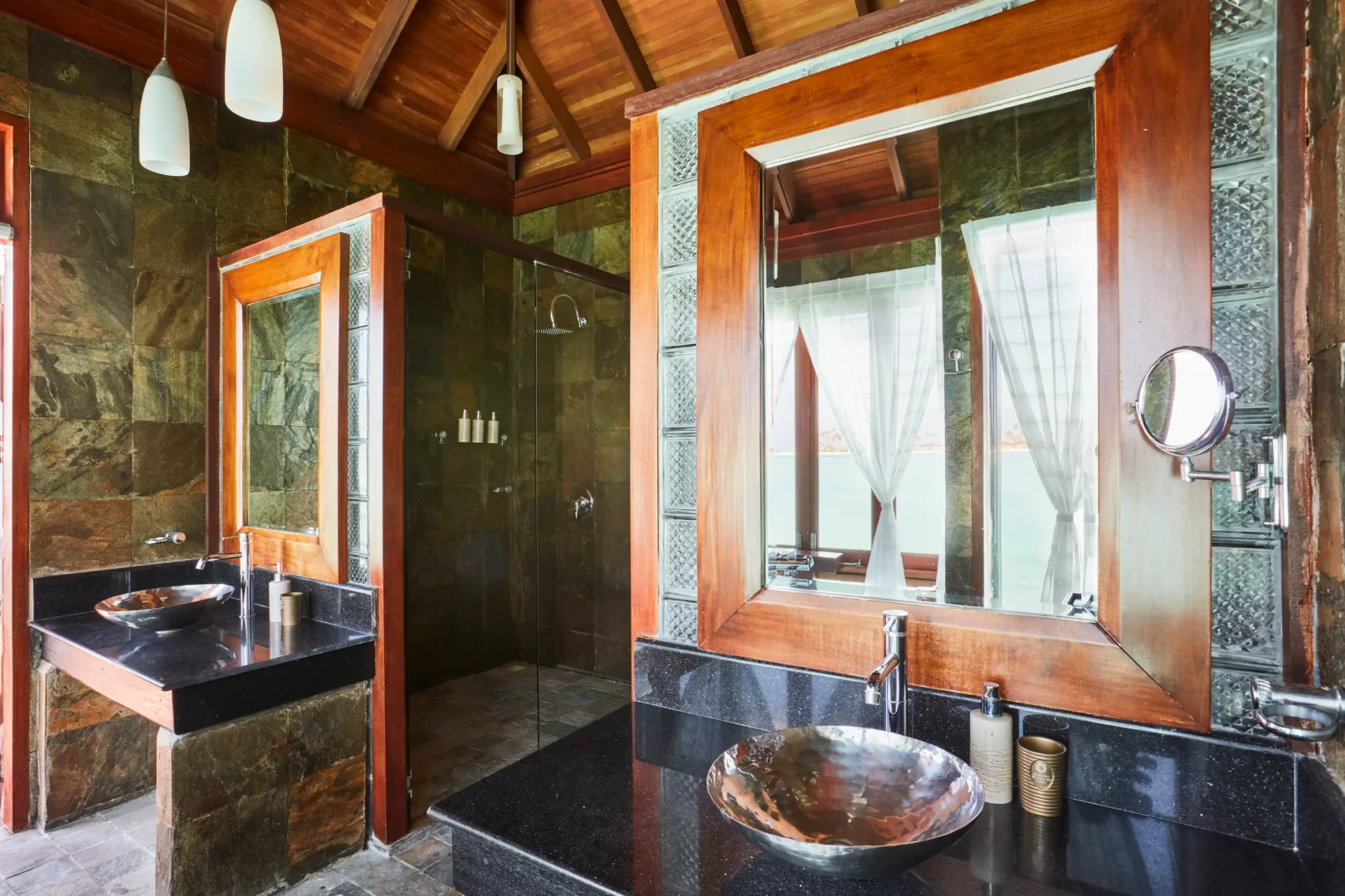 double vanity sink area in a deluxe water villa bathroom at sun siyam olhuveli maldives