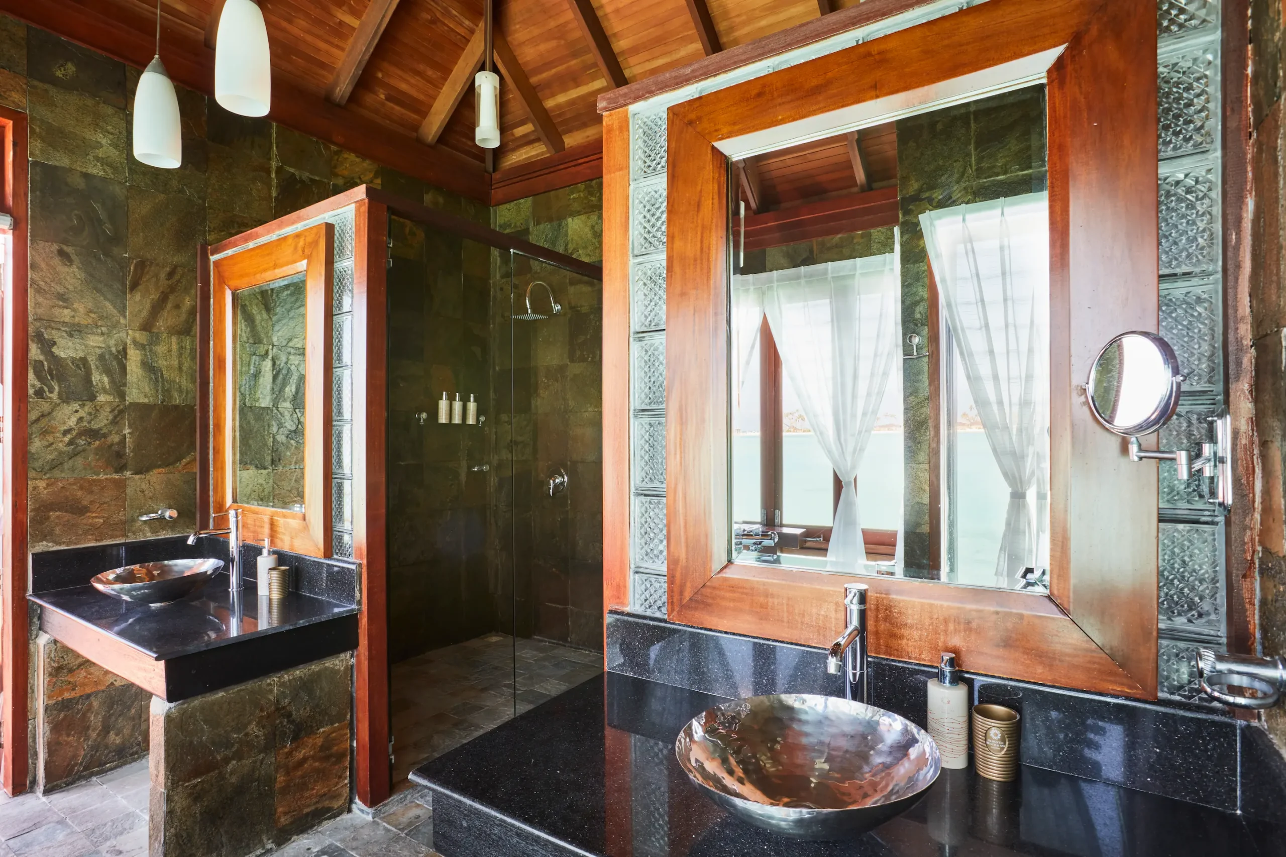 double vanity sink area in a deluxe water villa bathroom at sun siyam olhuveli maldives