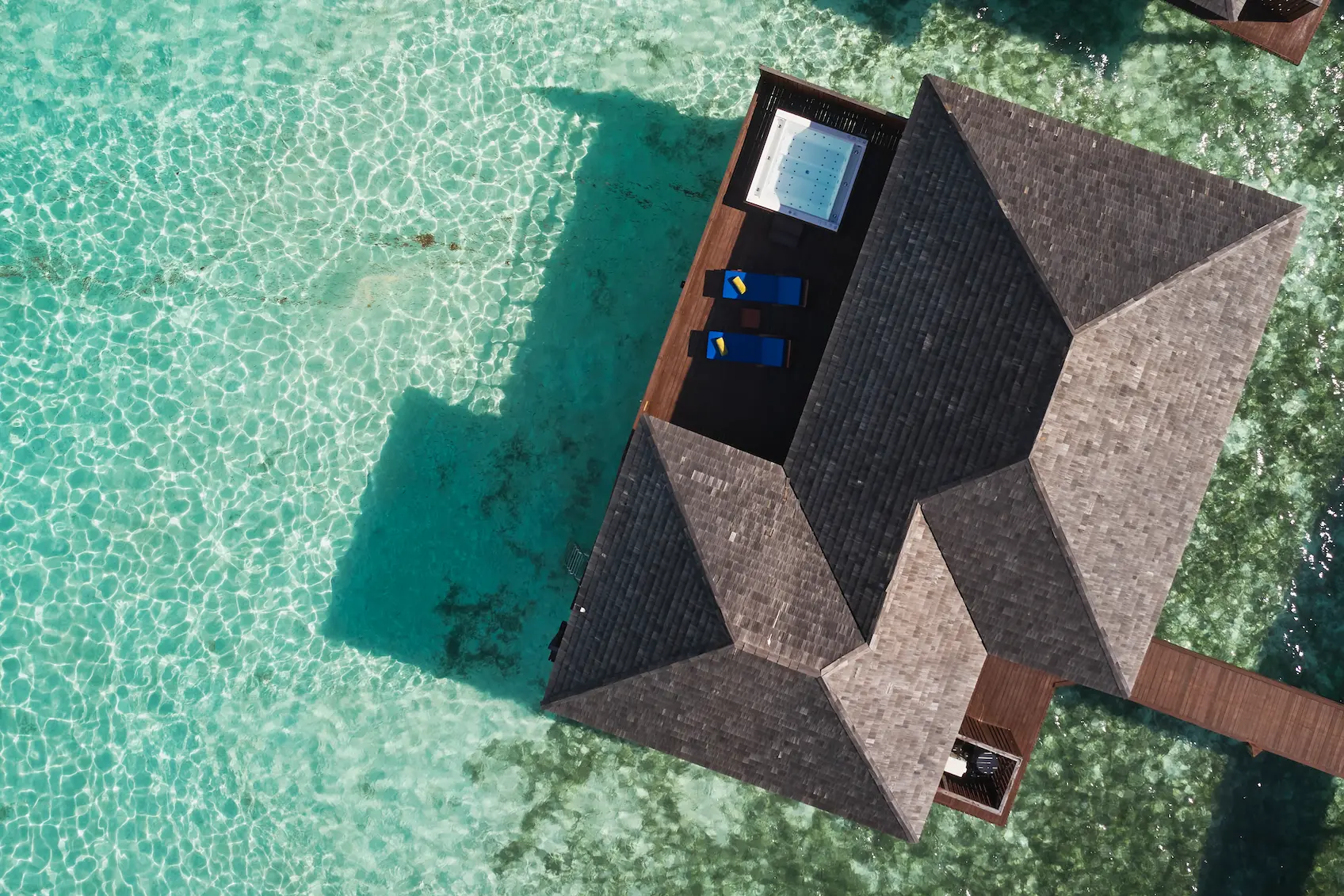aerial view of prestige jacuzzi water villas at sun siyam olhuveli maldives extending across the lagoon