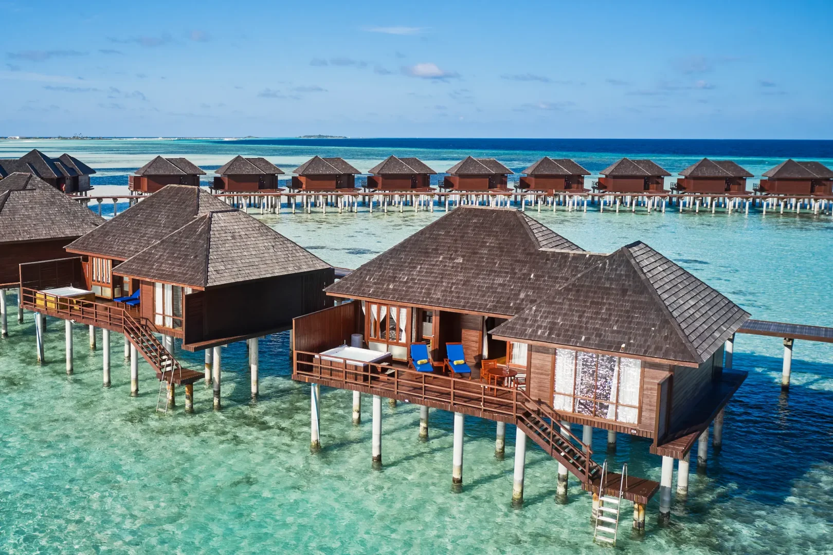 exterior view of a prestige jacuzzi water villa at sun siyam olhuveli maldives positioned above the lagoon with direct water access