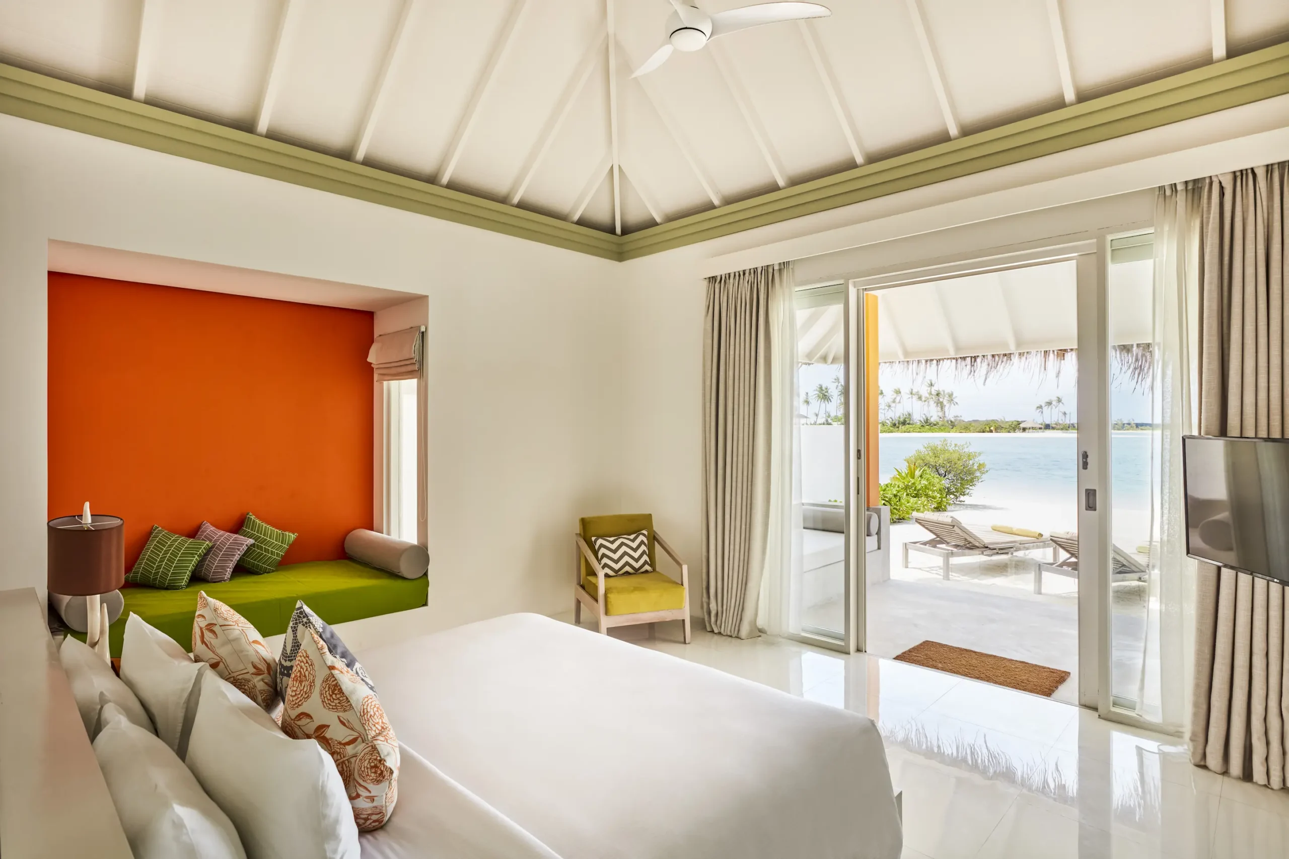 bedroom in a grand beach villa at sun siyam olhuveli maldives featuring contemporary furnishings and direct beach access