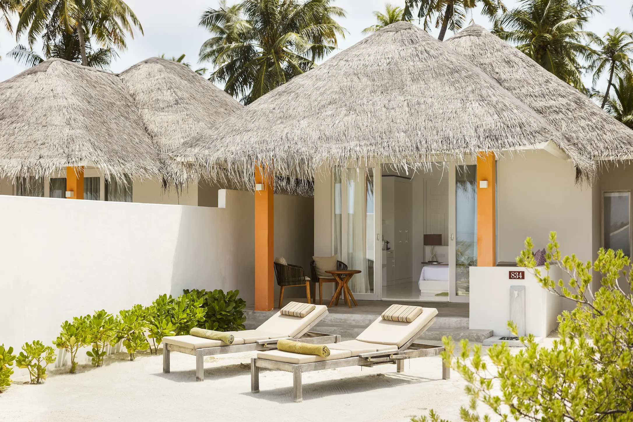 exterior view of a grand beach villa at sun siyam olhuveli maldives with direct beach access and private outdoor space