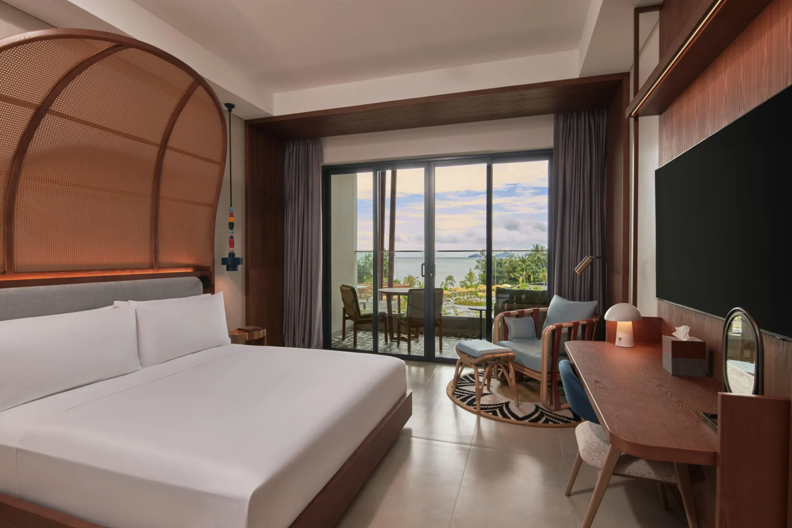 King Room with Pool View at Canopy by Hilton Seychelles Resort in Mahé, Seychelles, featuring a king-size bed, private balcony and views of the resort swimming pool.