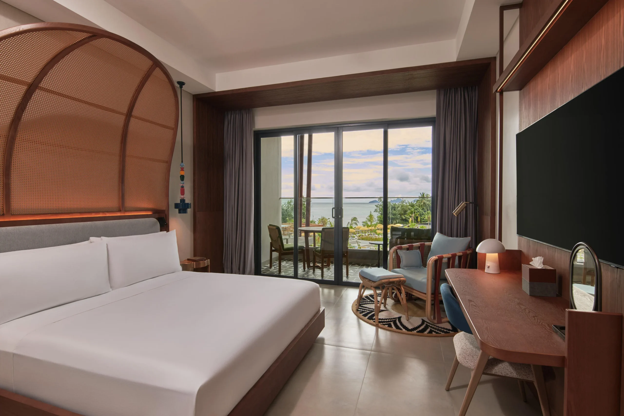 King Room with Pool View at Canopy by Hilton Seychelles Resort in Mahé, Seychelles, featuring a king-size bed, private balcony and views of the resort swimming pool.