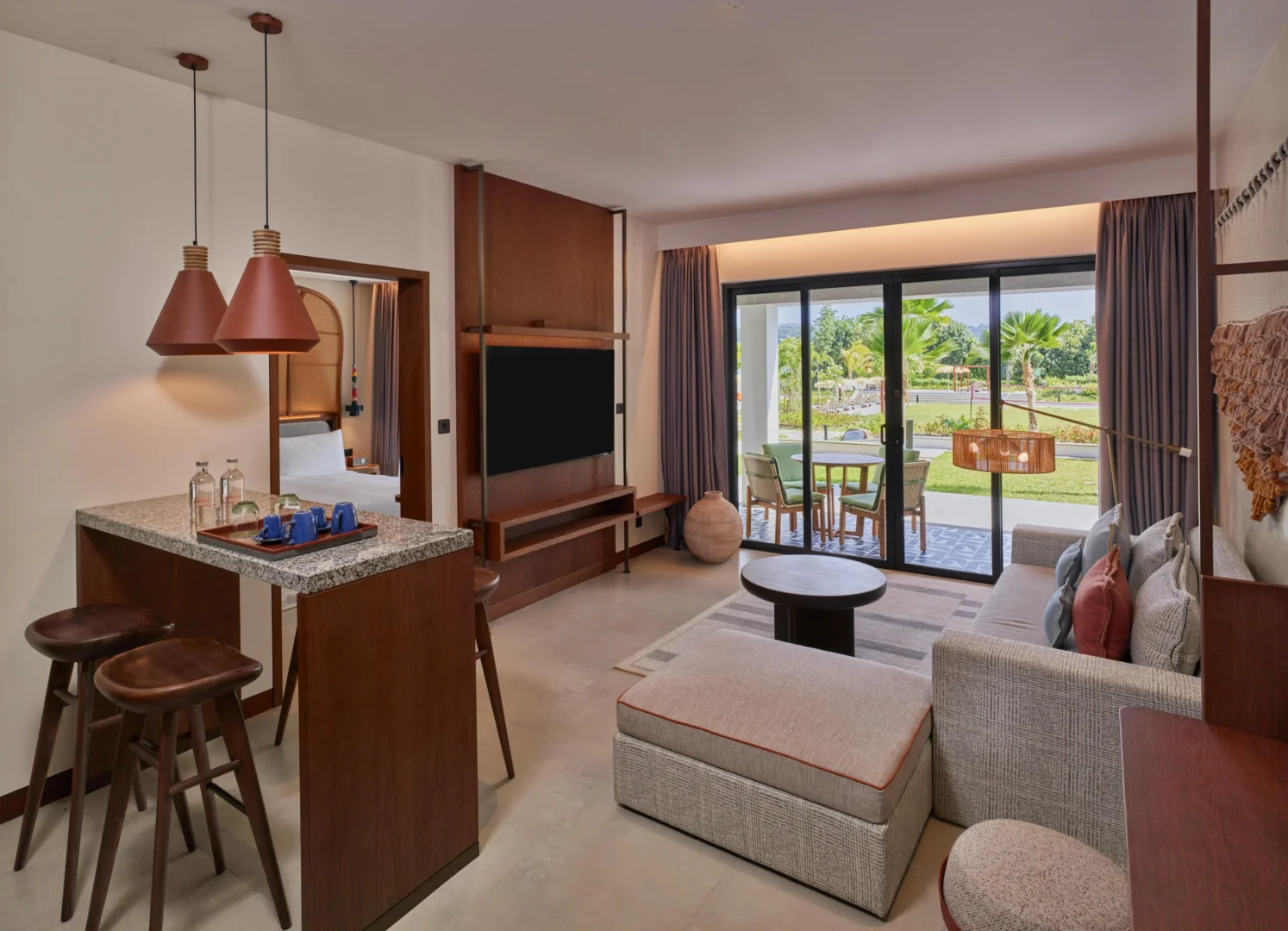 Living area in the One Bedroom Suite at Canopy by Hilton Seychelles Resort in Mahé, Seychelles, featuring separate lounge space and contemporary island-inspired design.