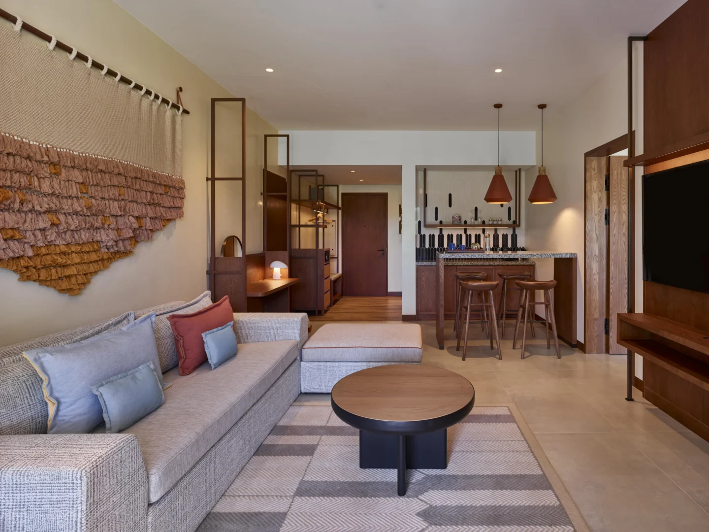 Kitchen area in the One Bedroom Suite at Canopy by Hilton Seychelles Resort in Mahé, Seychelles, featuring contemporary design and integrated dining and living space.