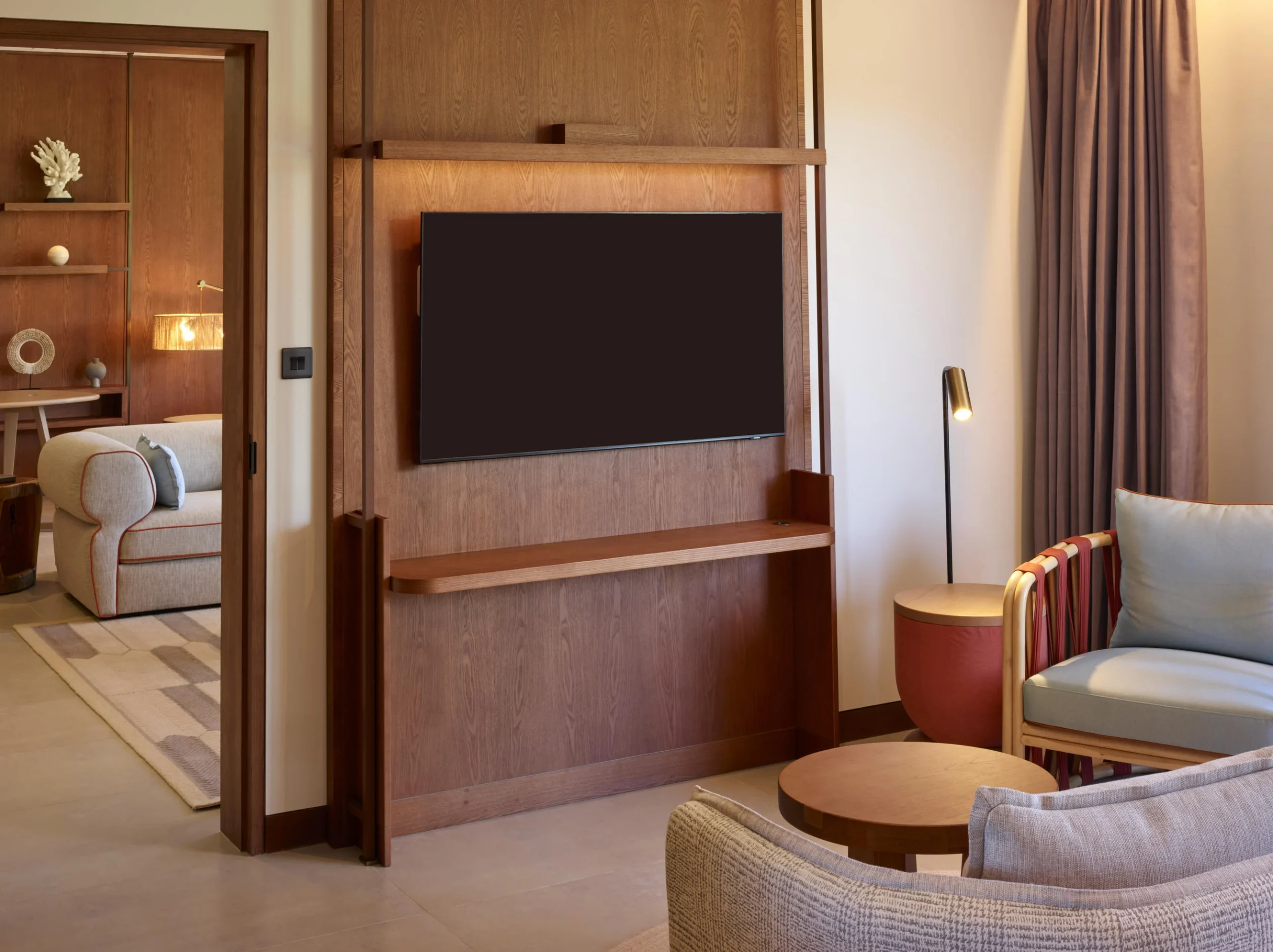 TV living area in the Two Bedroom Suite at Canopy by Hilton Seychelles Resort in Mahé, Seychelles, featuring a spacious lounge area with contemporary island-inspired décor.