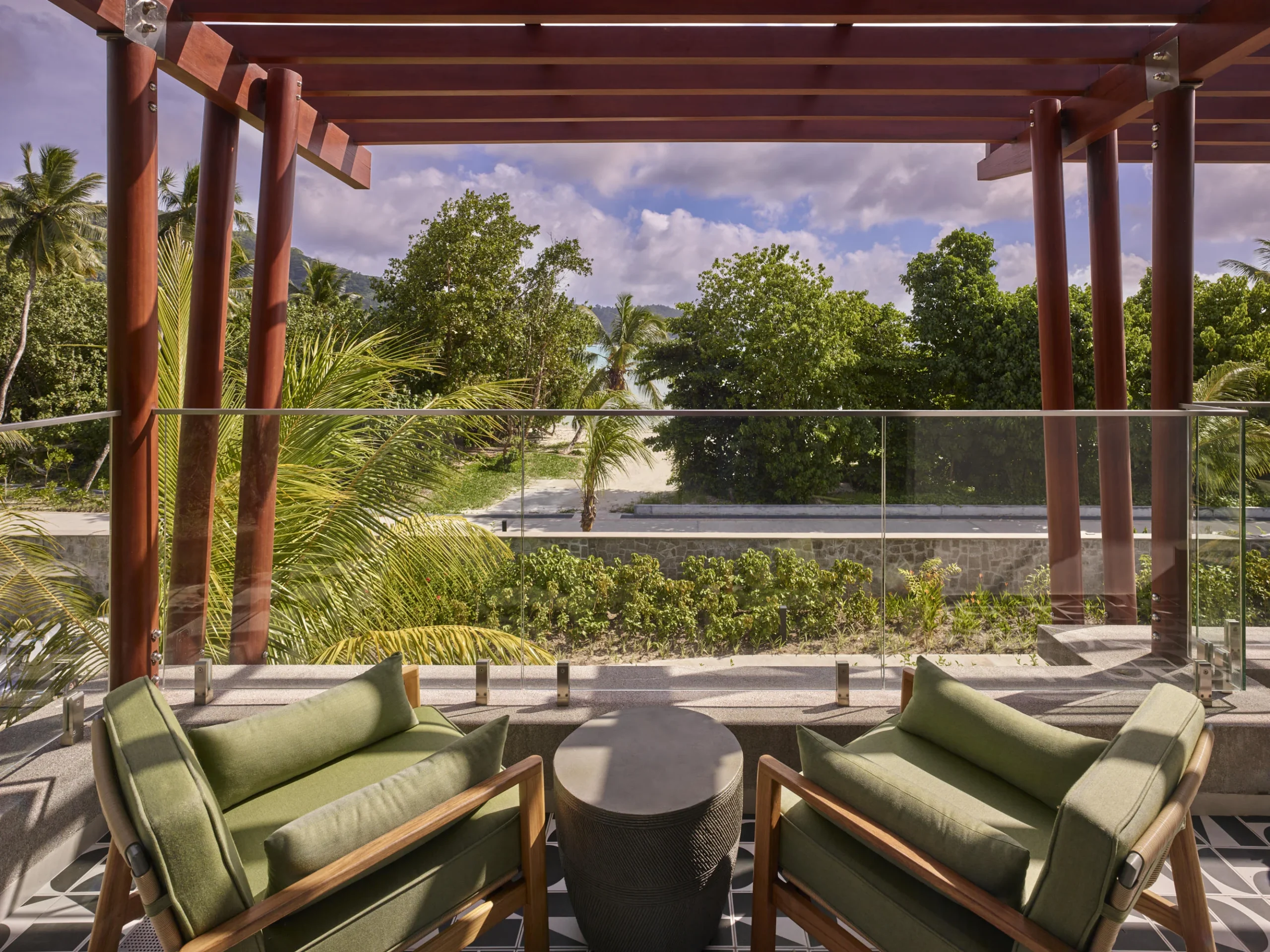 Balcony of the Two Bedroom Suite at Canopy by Hilton Seychelles Resort in Mahé, Seychelles, featuring outdoor seating and views across the resort surroundings.