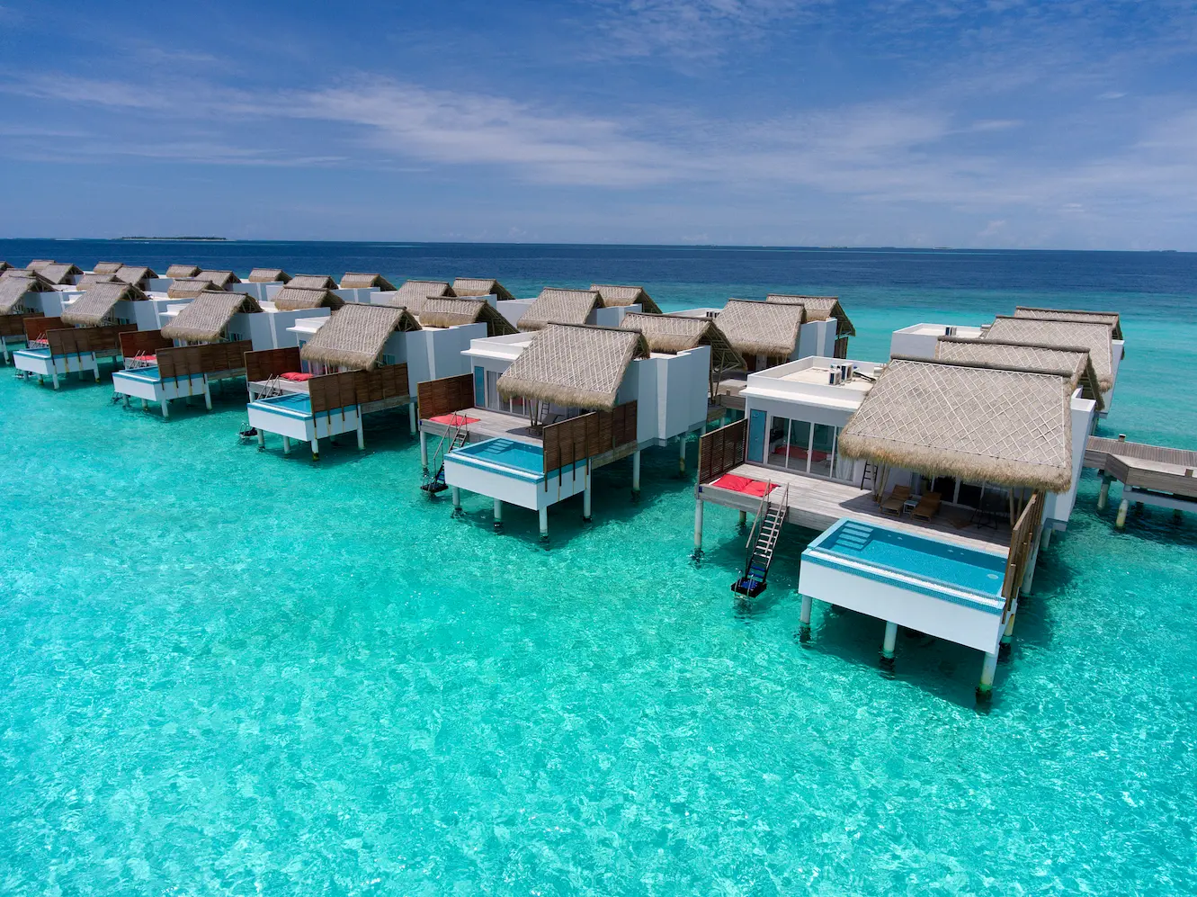 exterior of a water villa with pool at emerald maldives resort & spa in the maldives set above the lagoon with a private pool, sundeck and direct ocean access