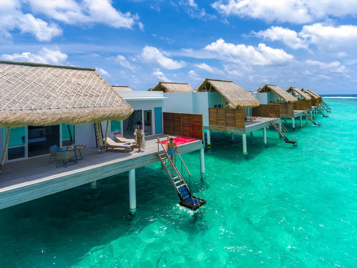 exterior of a water villa at emerald maldives resort & spa in the maldives set above the lagoon with a private sundeck and direct ocean access