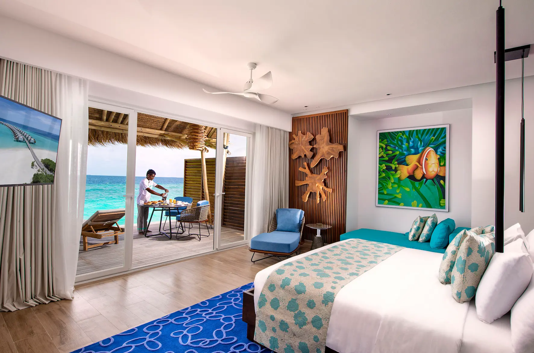 interior of a water villa at emerald maldives resort & spa in the maldives featuring contemporary furnishings, spacious living areas and direct access to a private overwater sundeck