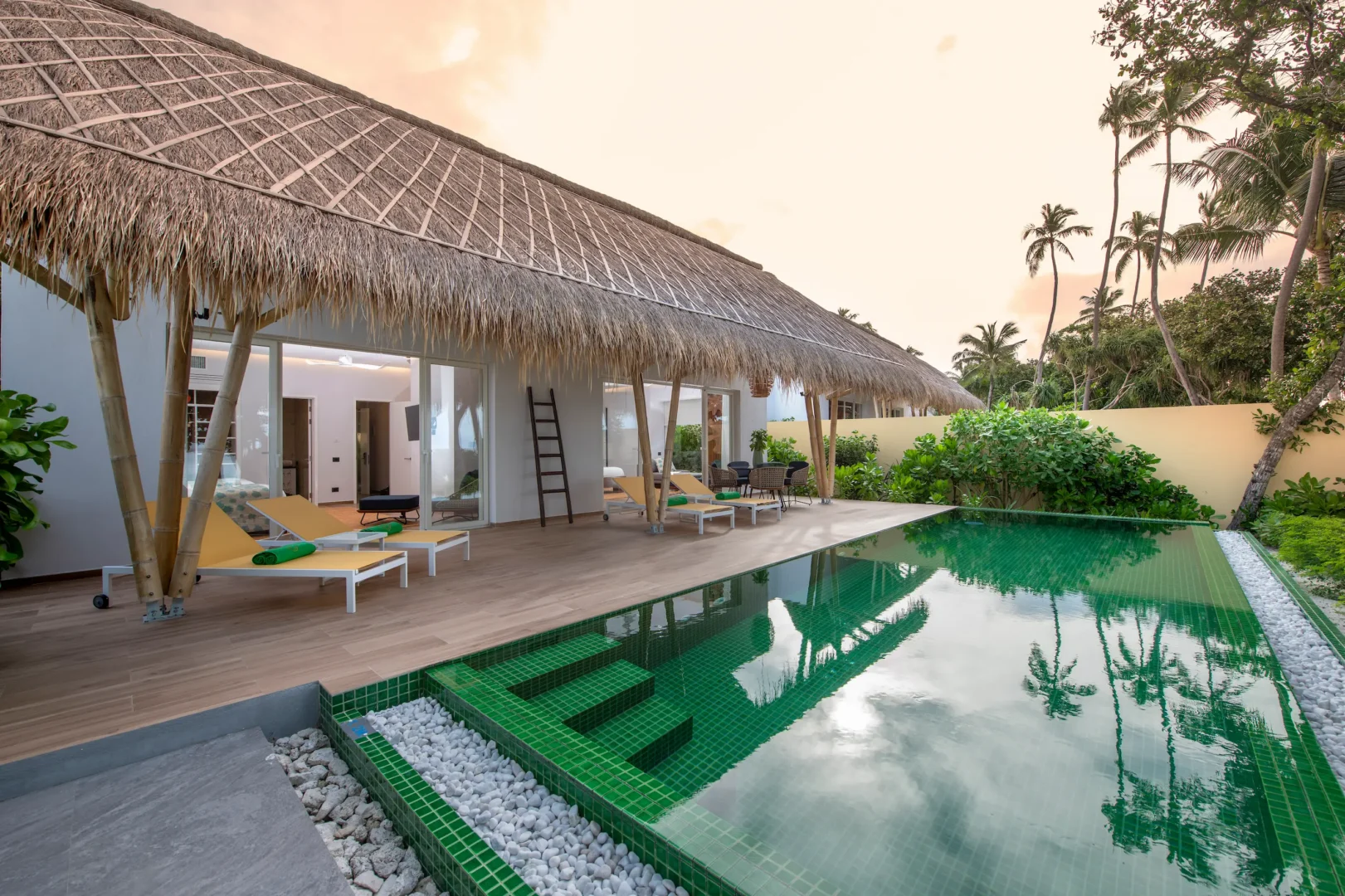 exterior of a family beach villa with pool at emerald maldives resort & spa in the maldives featuring a private pool, spacious outdoor terrace and direct beach access