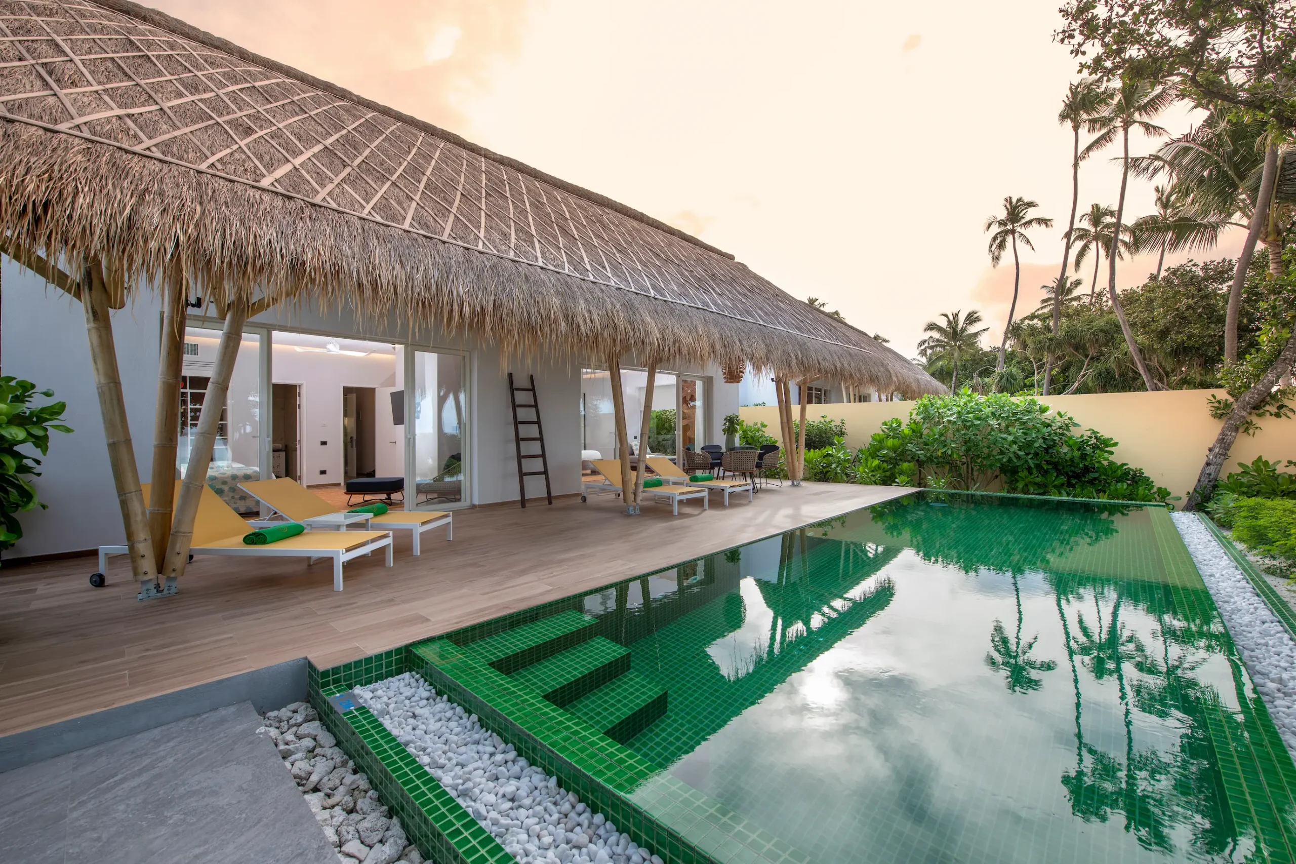 exterior of a family beach villa with pool at emerald maldives resort & spa in the maldives featuring a private pool, spacious outdoor terrace and direct beach access