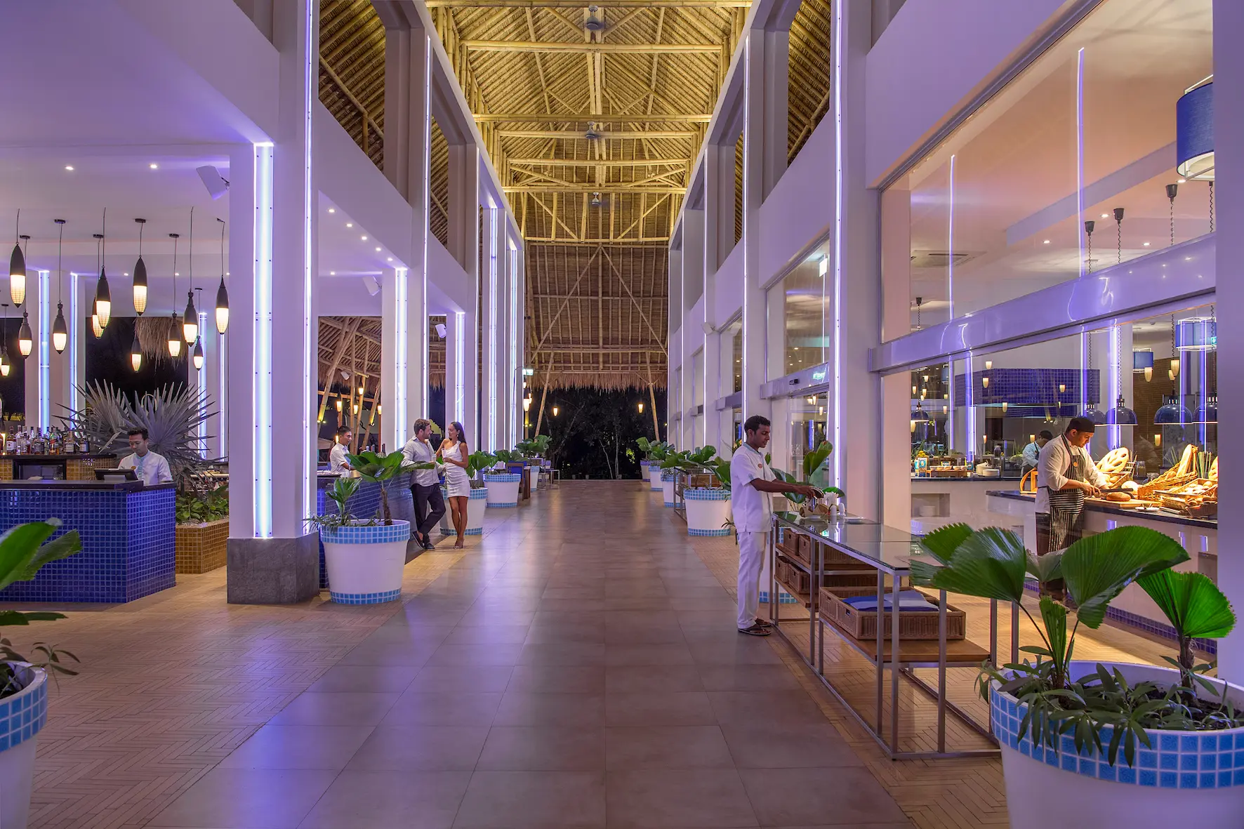 aqua restaurant at emerald maldives resort & spa in the maldives featuring beachfront dining, indoor and outdoor seating and international buffet cuisine