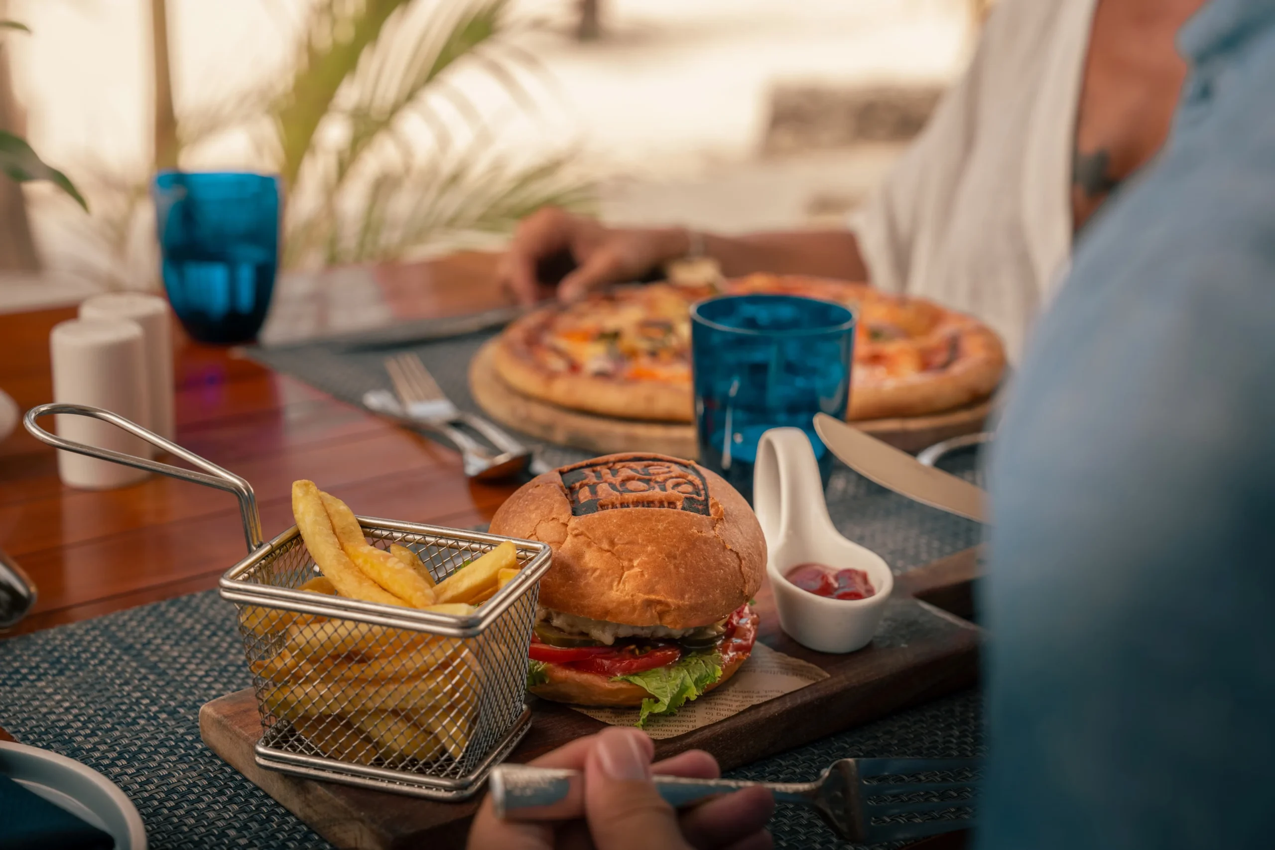 Beachfront lunch at Muyuni Beach Club at The Mora Zanzibar, serving Mediterranean-inspired cuisine with views across the Indian Ocean.
