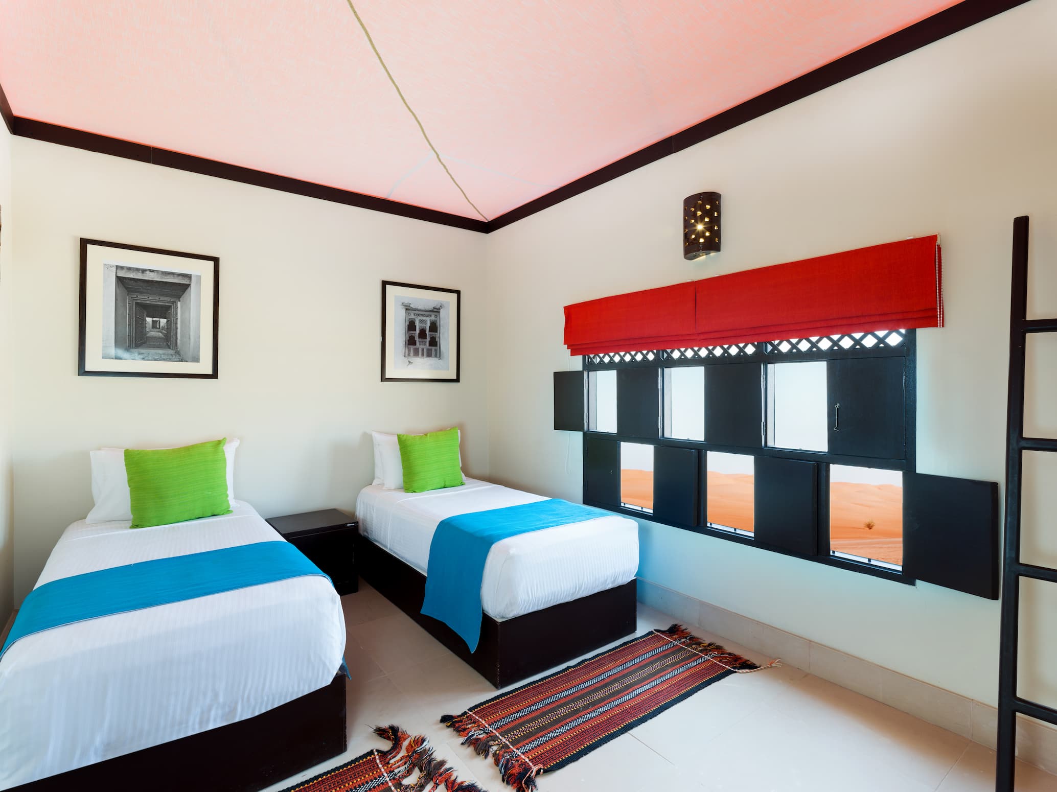Twin bedroom inside a Two Bedroom Villa at Desert Nights Resort Oman featuring comfortable family accommodation in the Wahiba Sands desert