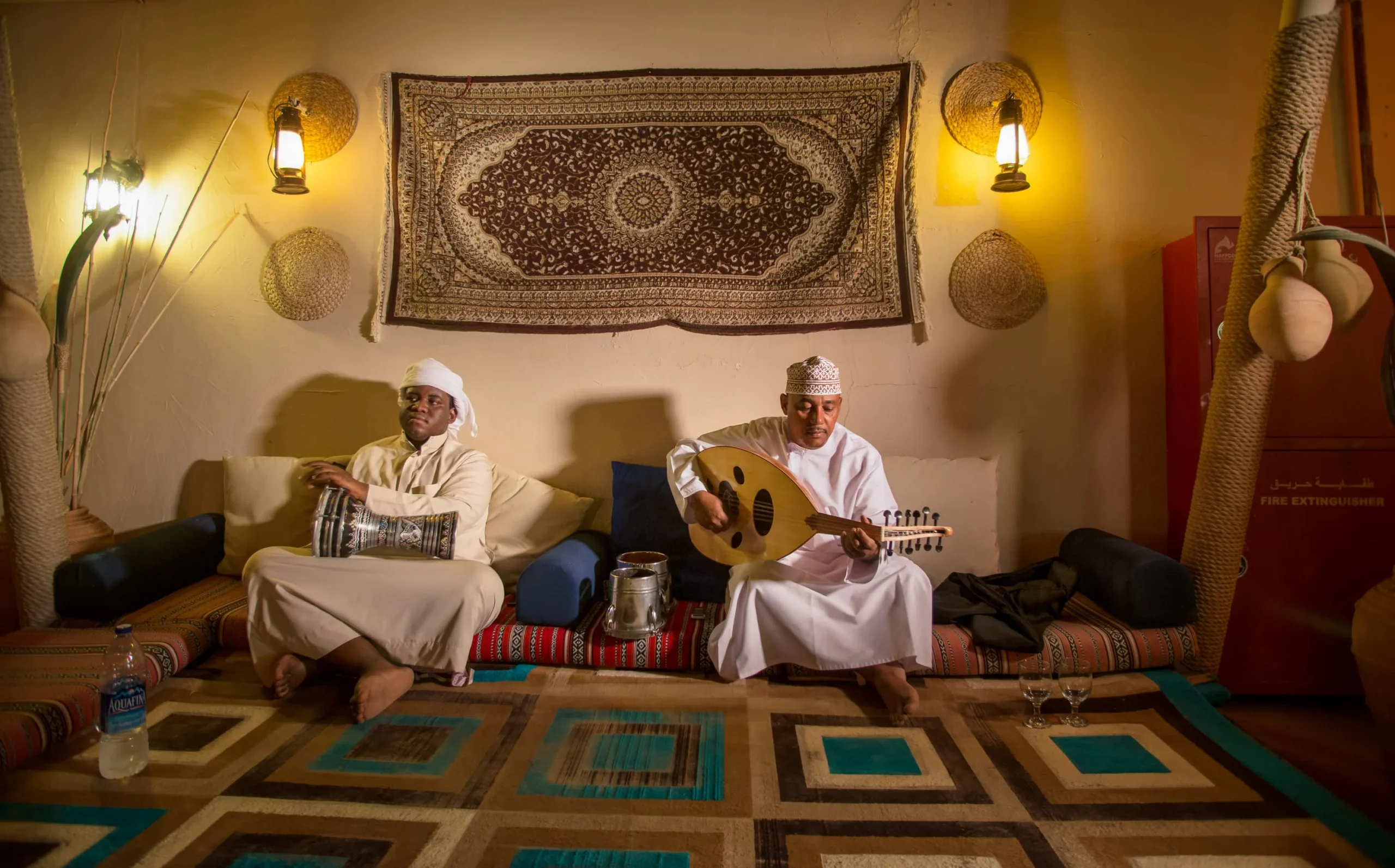 Traditional live musicians performing during an evening dining experience at Desert Nights Resort Oman in the Wahiba Sands desert