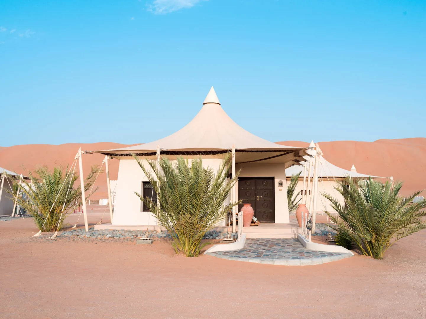 Exterior view of a Deluxe Villa at Desert Nights Resort Oman set among the dunes of the Wahiba Sands