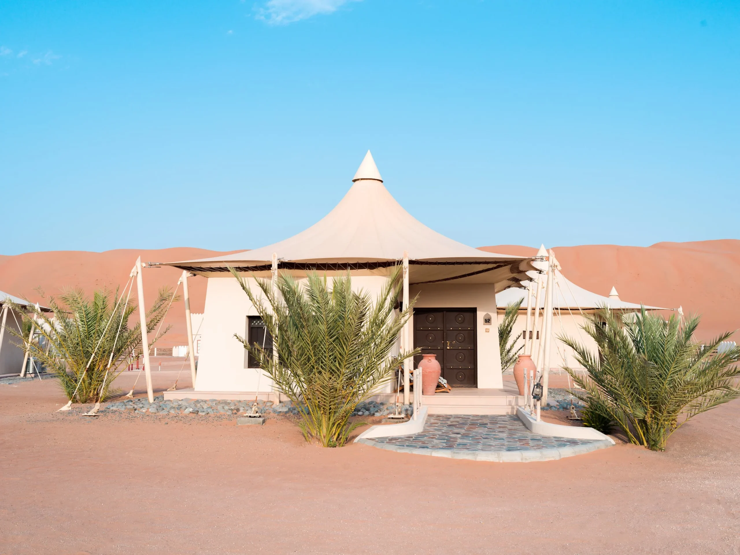 Exterior view of a Deluxe Villa at Desert Nights Resort Oman set among the dunes of the Wahiba Sands