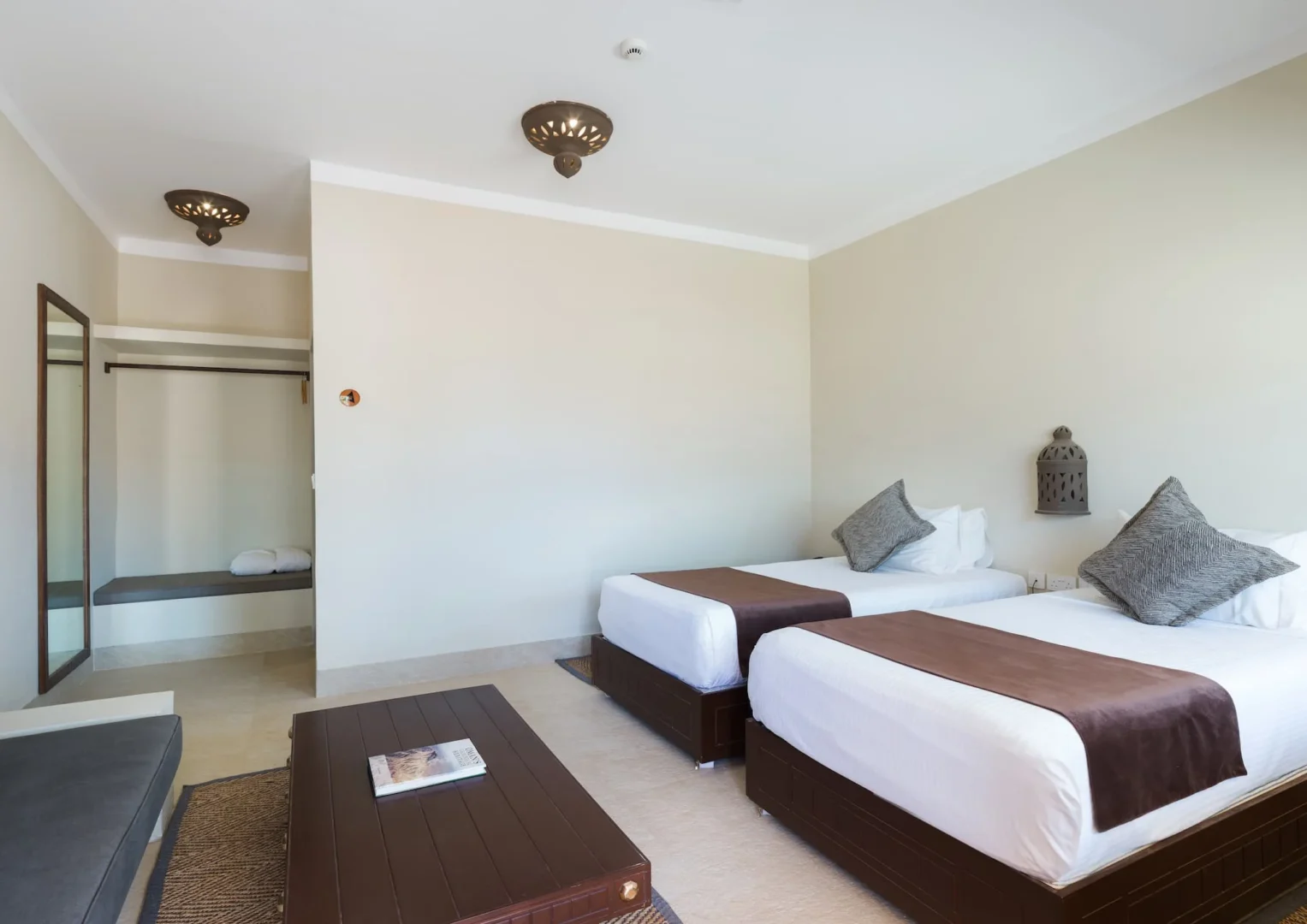 Interior of a Deluxe Room at Desert Nights Resort Oman featuring a king bed and modern amenities in the Wahiba Sands desert